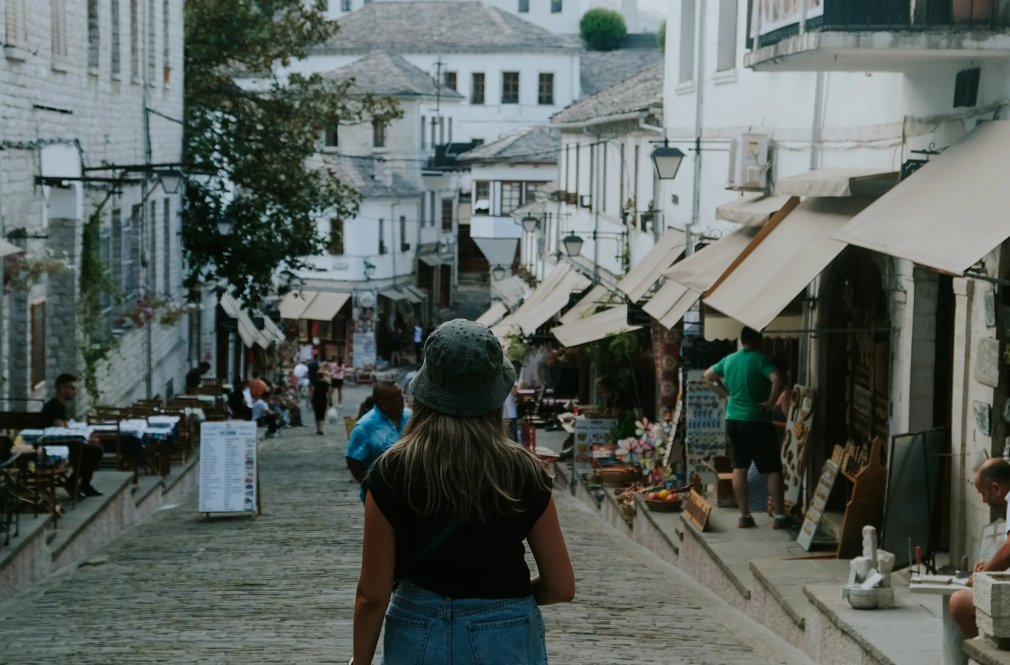 Letizia walking down a narrow, traditional cobbled street in the UNESCO World Heritage town of Berat.
