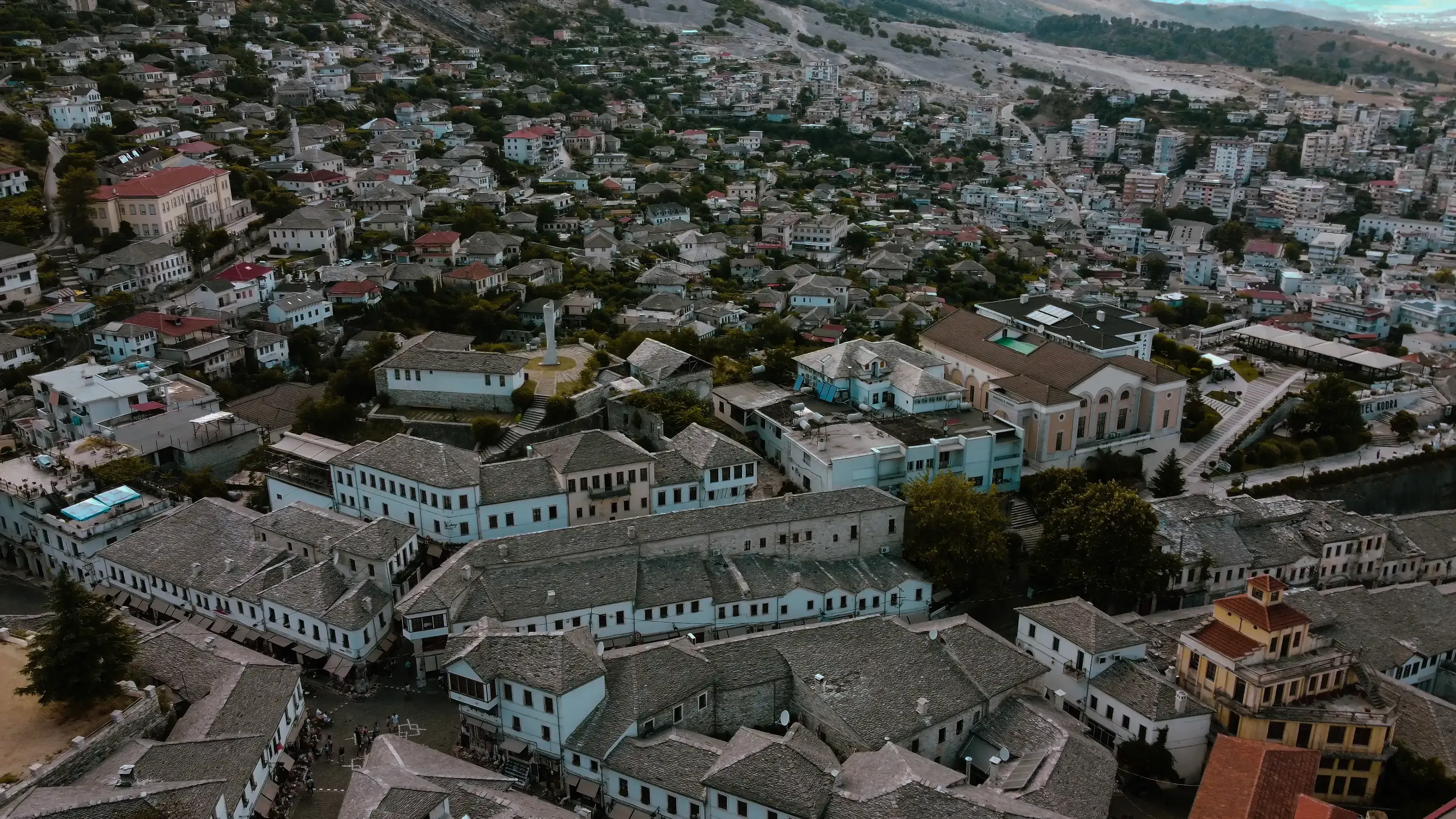 A sweeping view of the Ottoman-style houses with stone roofs in Gjirokastër, seen from the massive Gjirokastër Castle fortress.