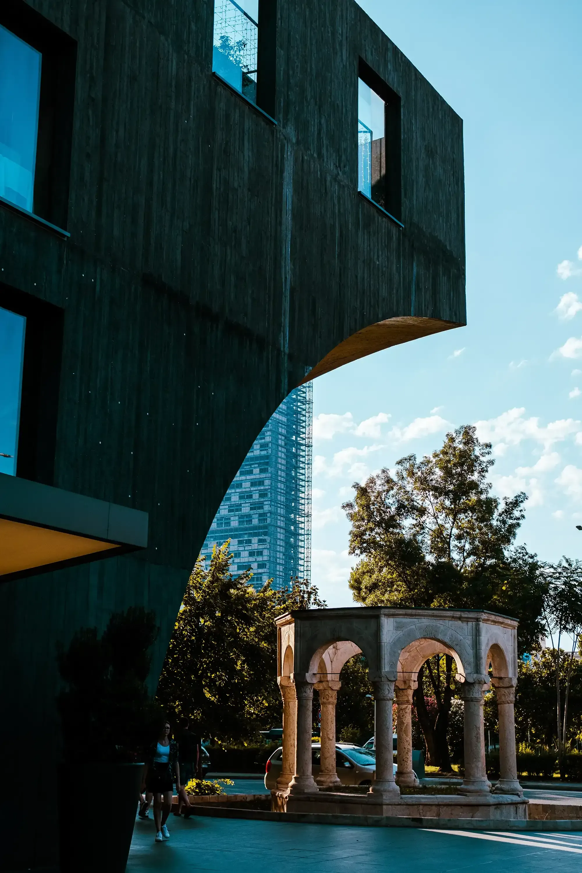 Remnants of an ancient Roman structure visible amidst the modern architecture of downtown Tirana.