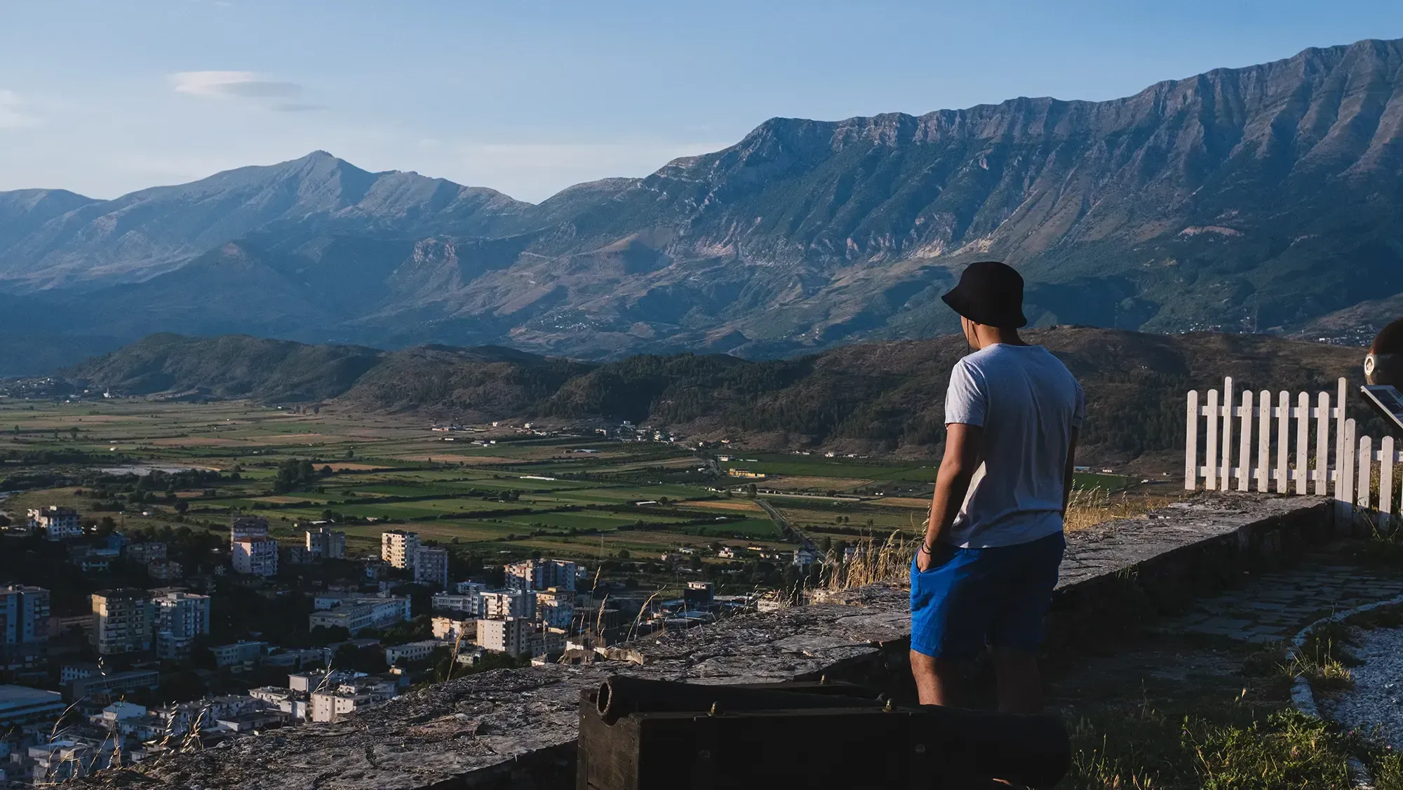 Ieser standing or sitting on the massive defensive wall of the Gjirokastër Castle fortress.