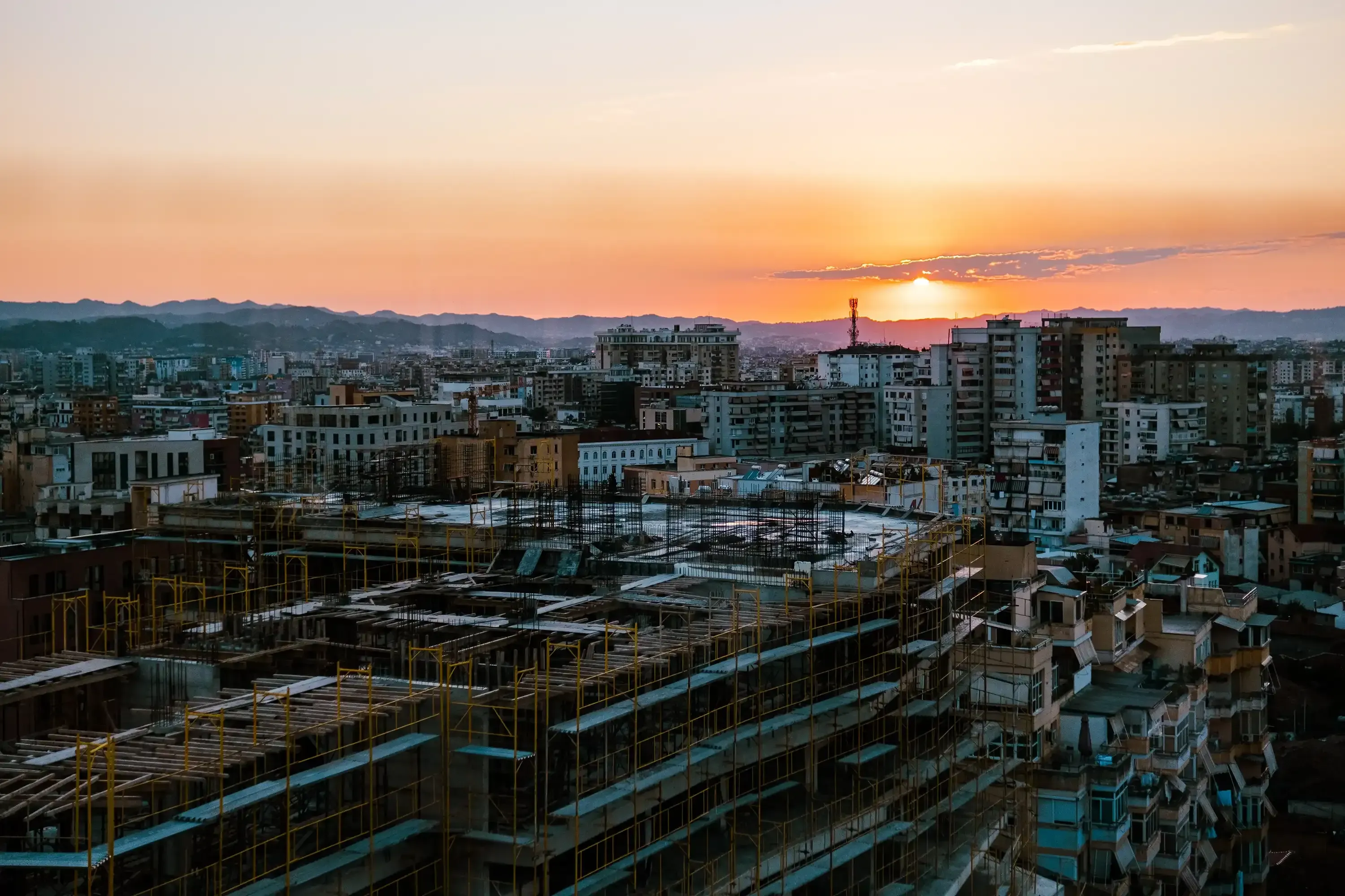 Panoramic view of the cityscape of Tirana as seen from the top of a modern skyscraper.