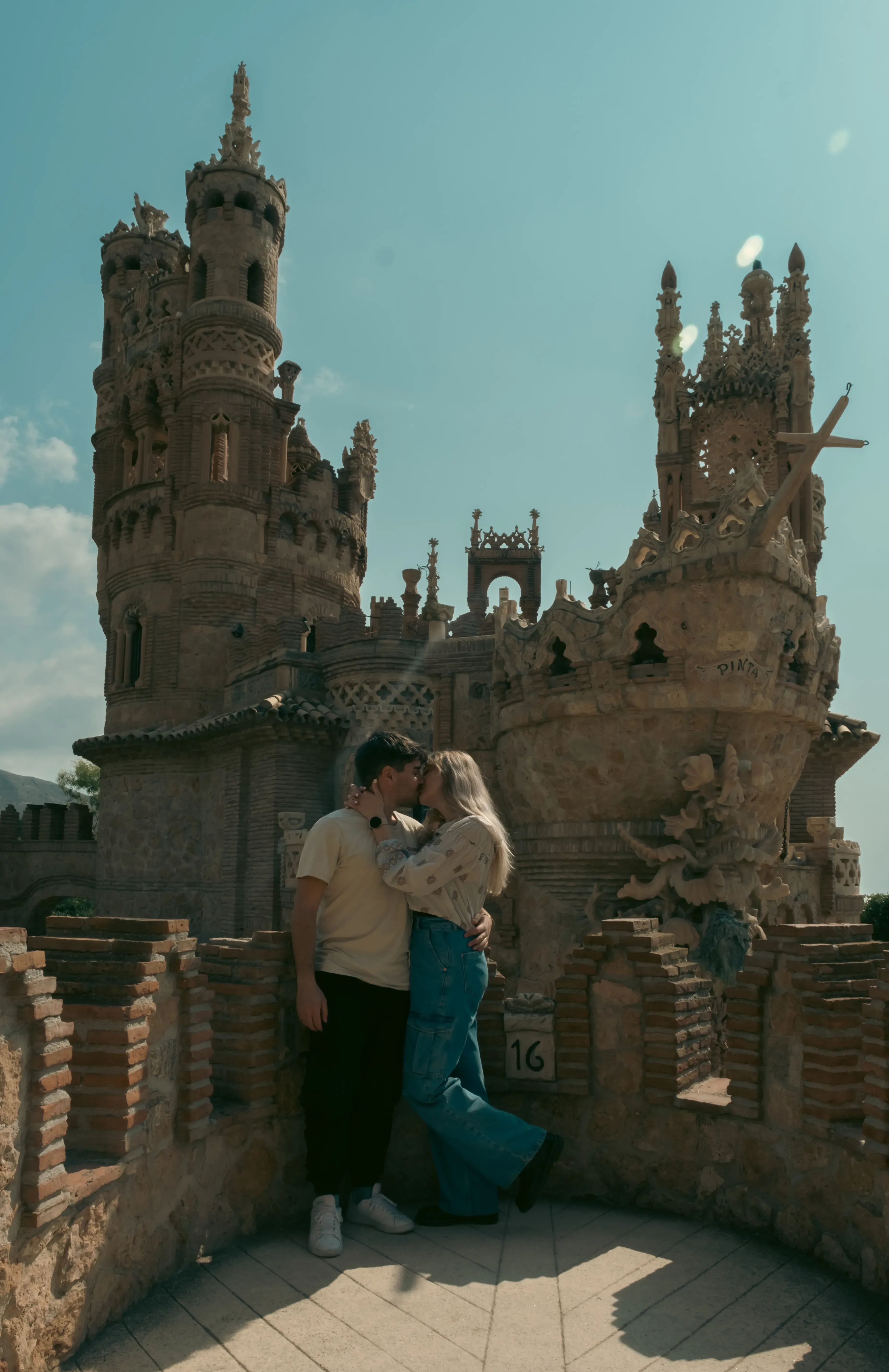 Ieser and Letizia embracing each other while standing on the highest terrace of Castillo de Colomares.