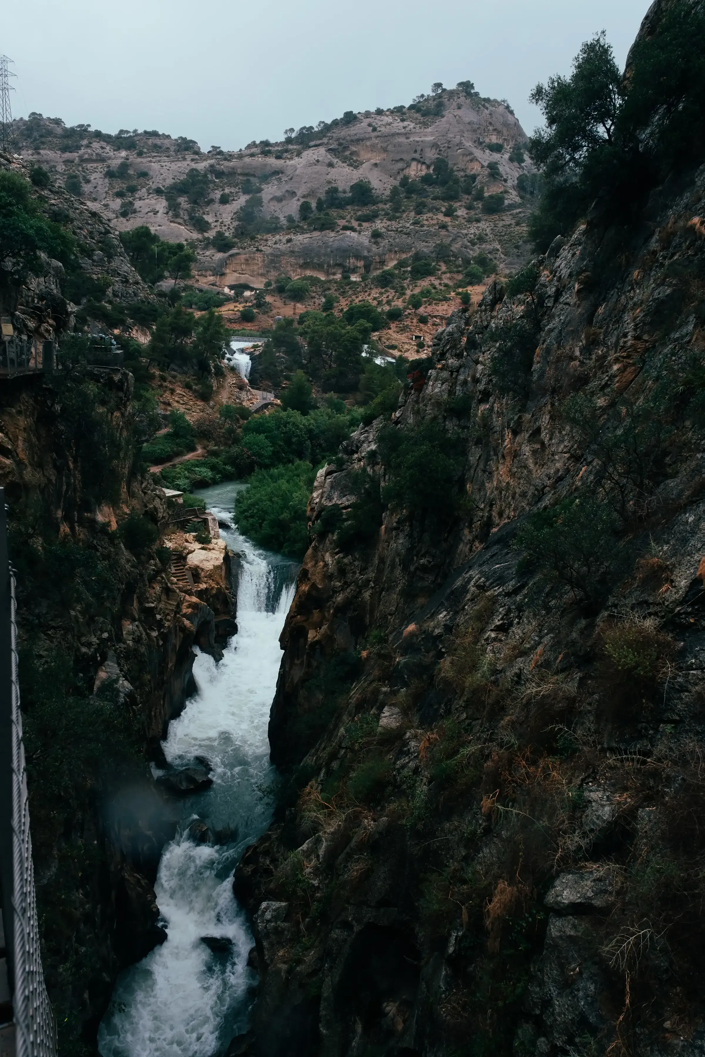 The turquoise waters of the Guadalhorce River flowing through the deep, carved canyon below the Caminito del Rey hiking trail.
