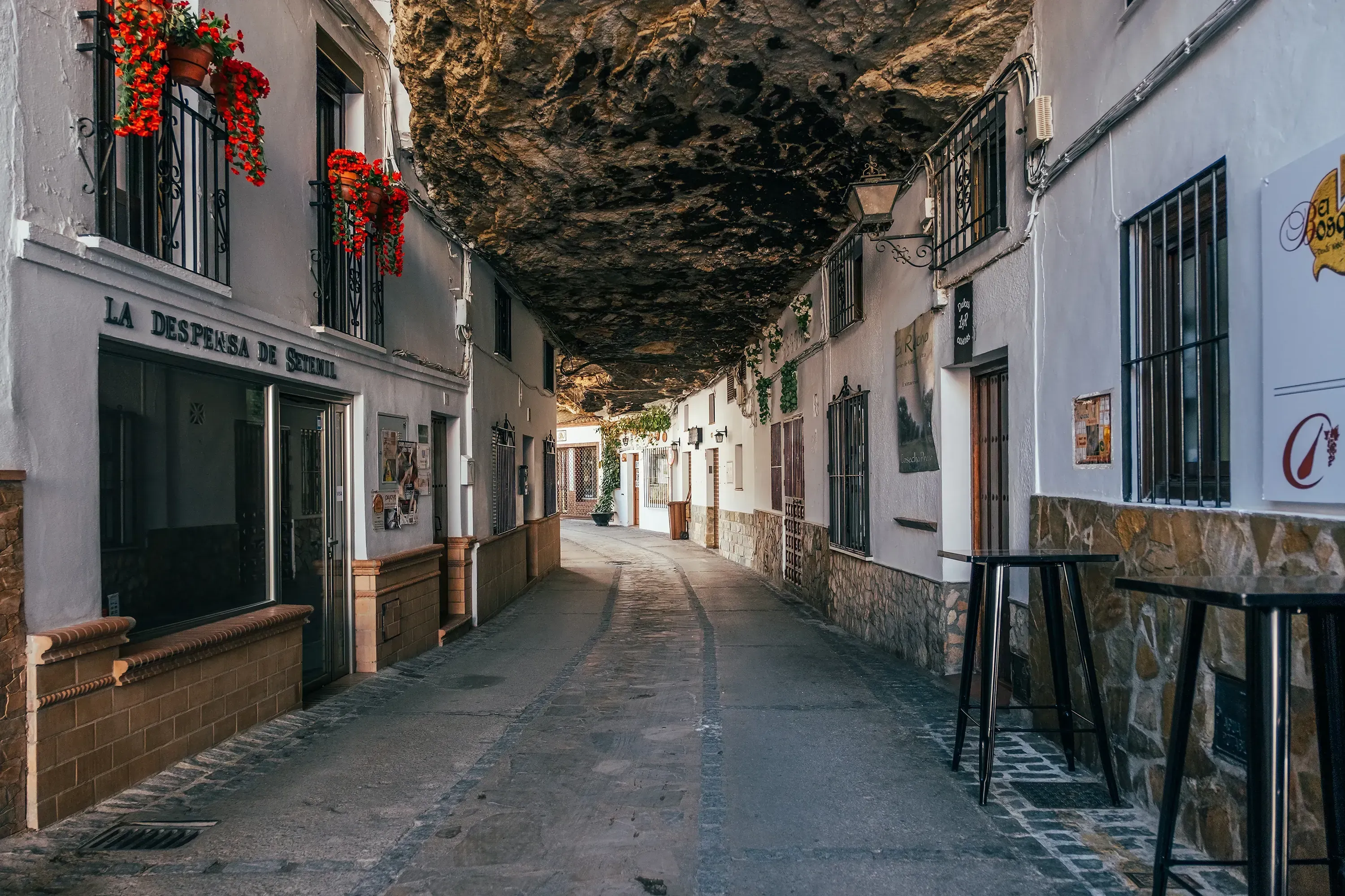 Houses built directly underneath a massive rock overhang in Setenil de las Bodegas.
