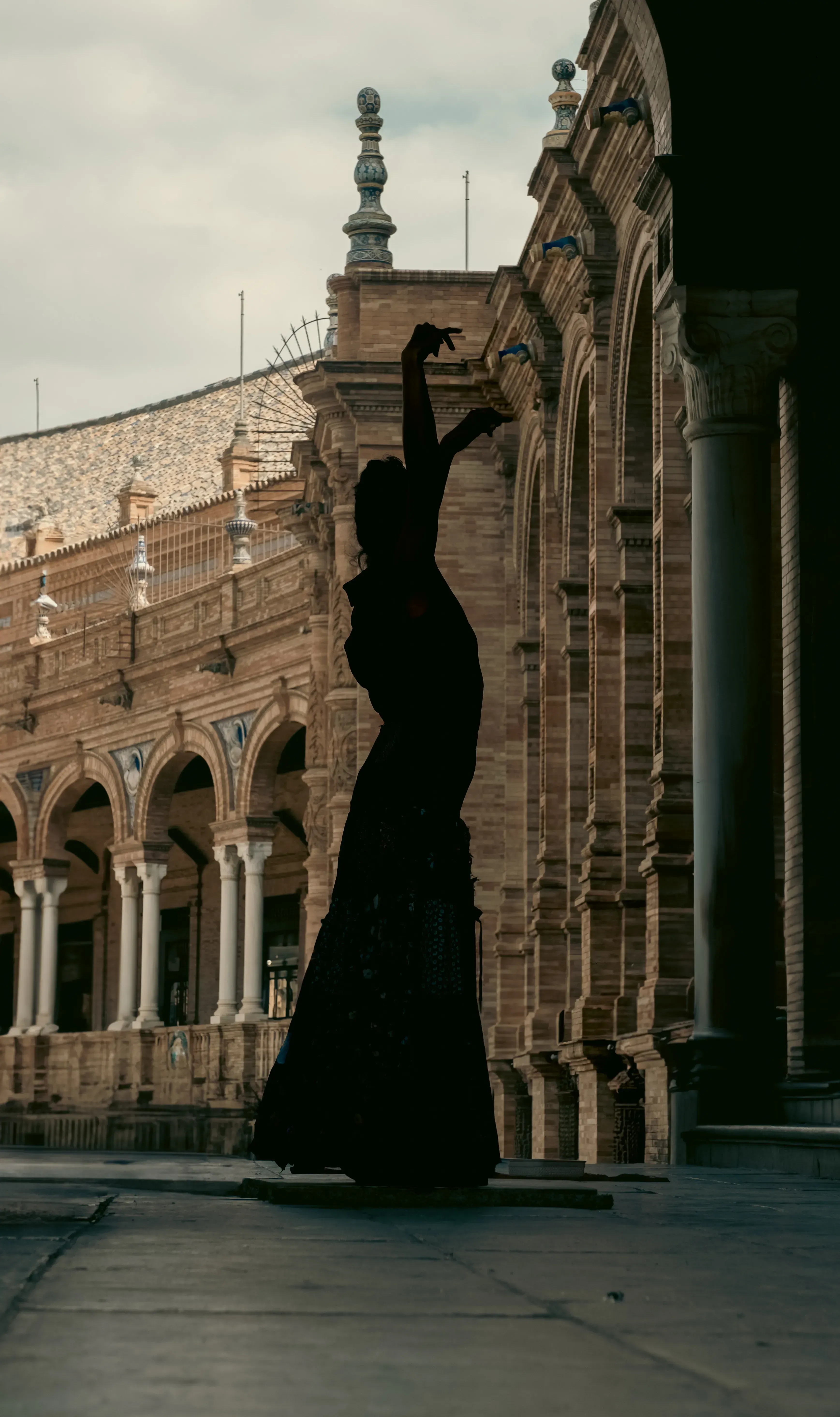 A woman dancing flamenco in the open area of Plaza de España.