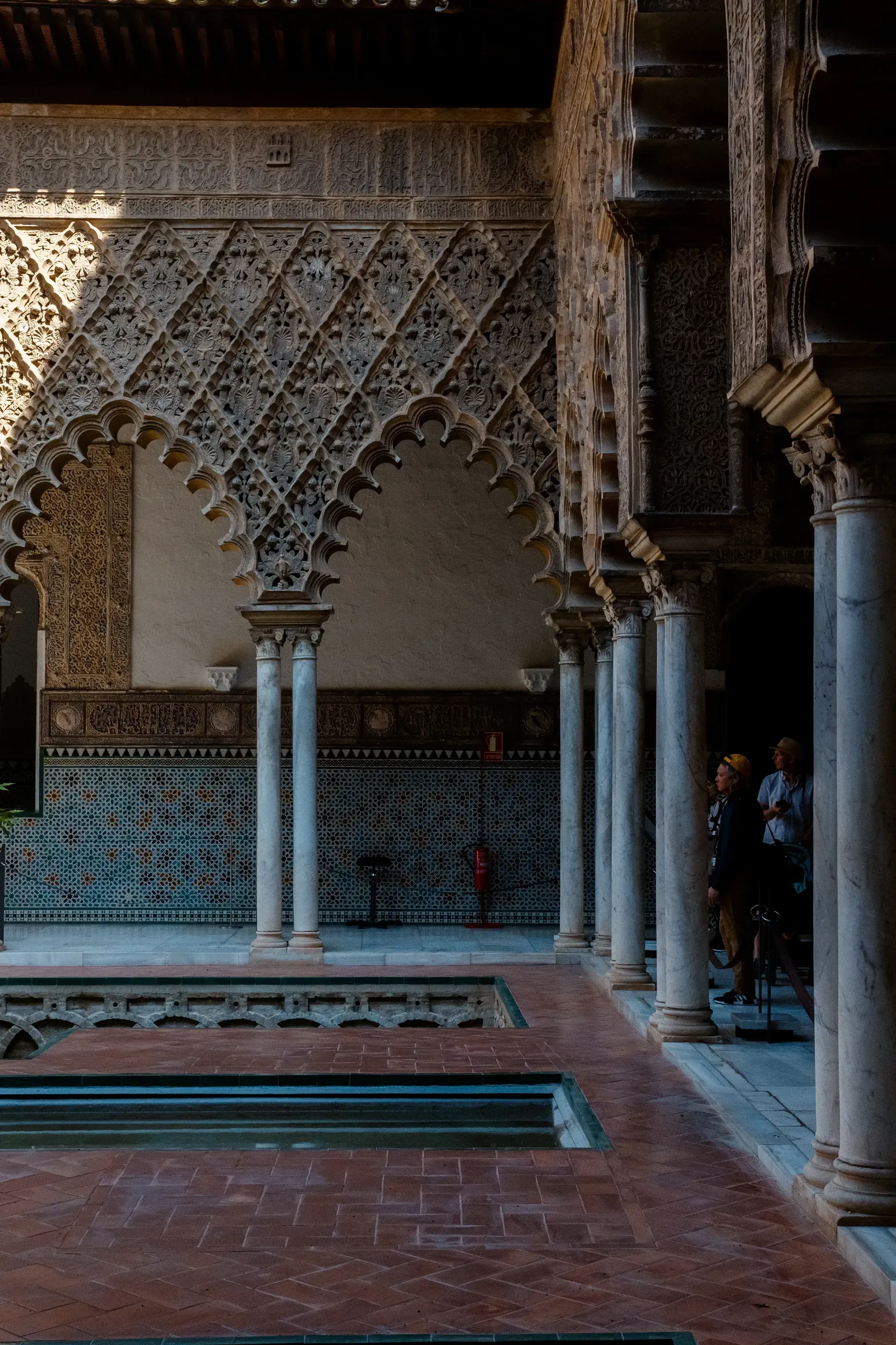 The serene courtyard pool or bath within the Alcázar palace.