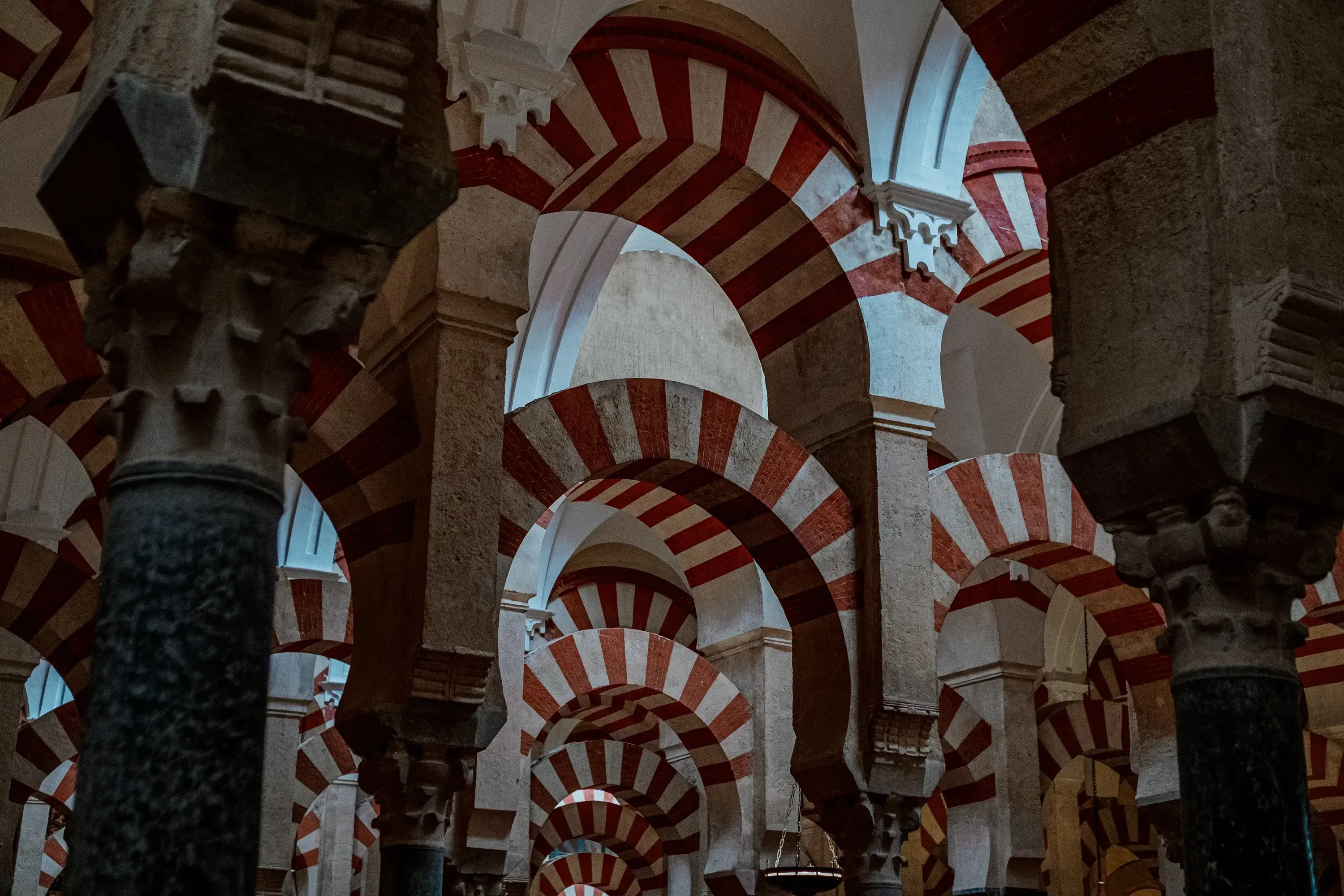 The famous red and white striped double arches inside the Mezquita (Mosque-Cathedral) of Córdoba.