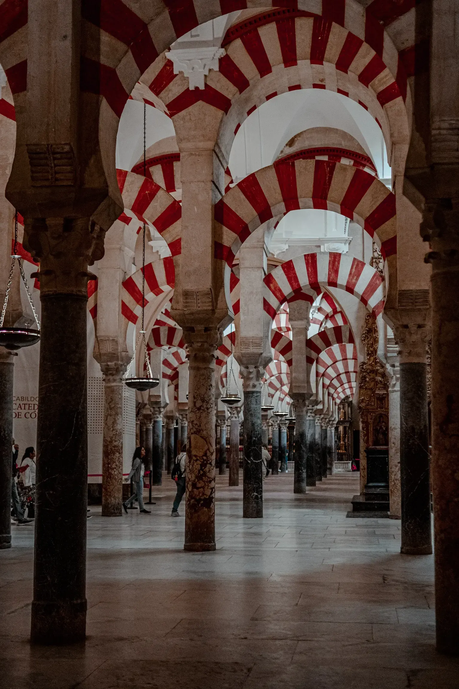 The famous red and white striped double arches inside the Mezquita (Mosque-Cathedral) of Córdoba.