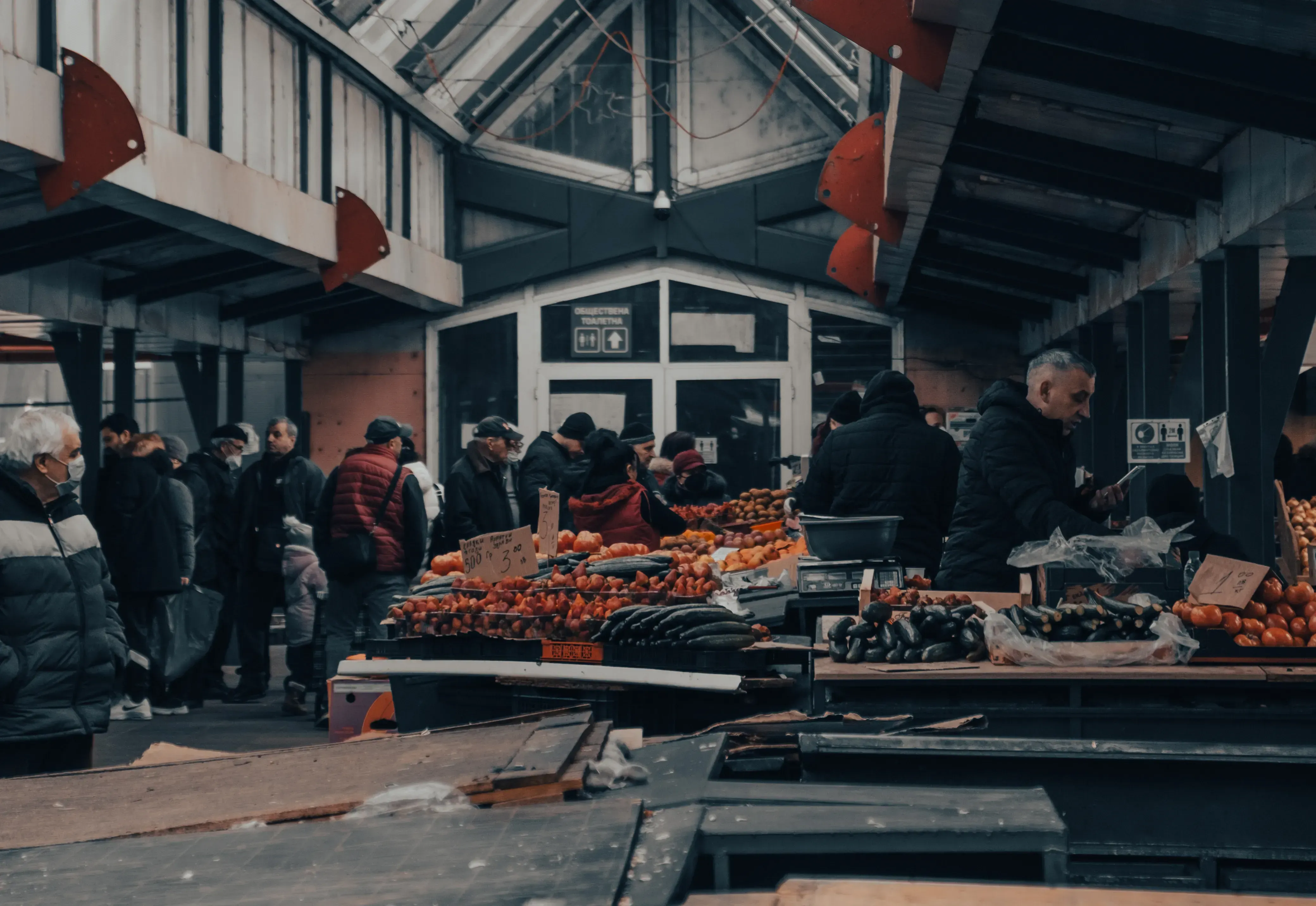 Market stall in Sofia with a vendor interacting with customers.