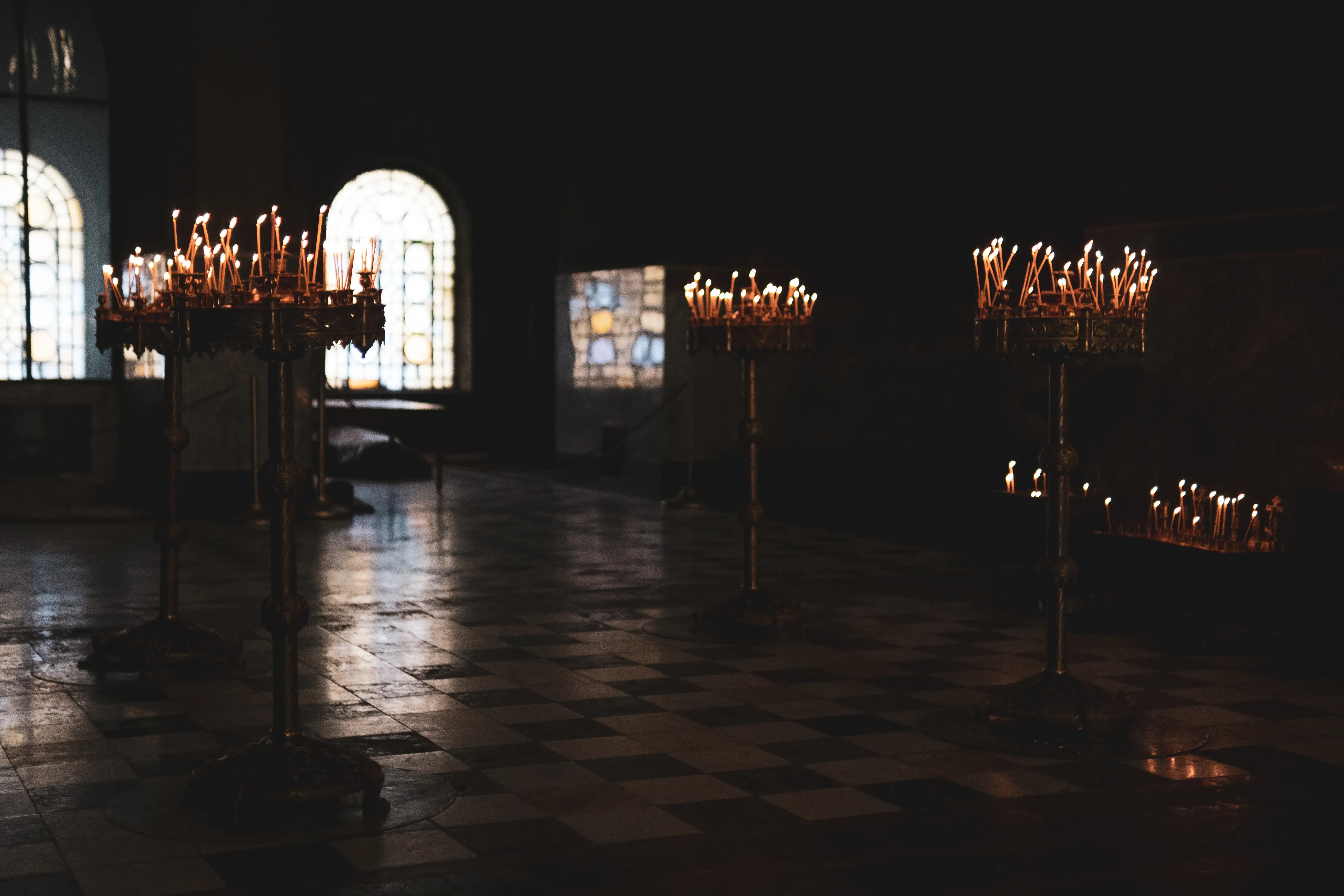 Ornate chandeliers hanging inside the Alexander Nevsky Cathedral interior.