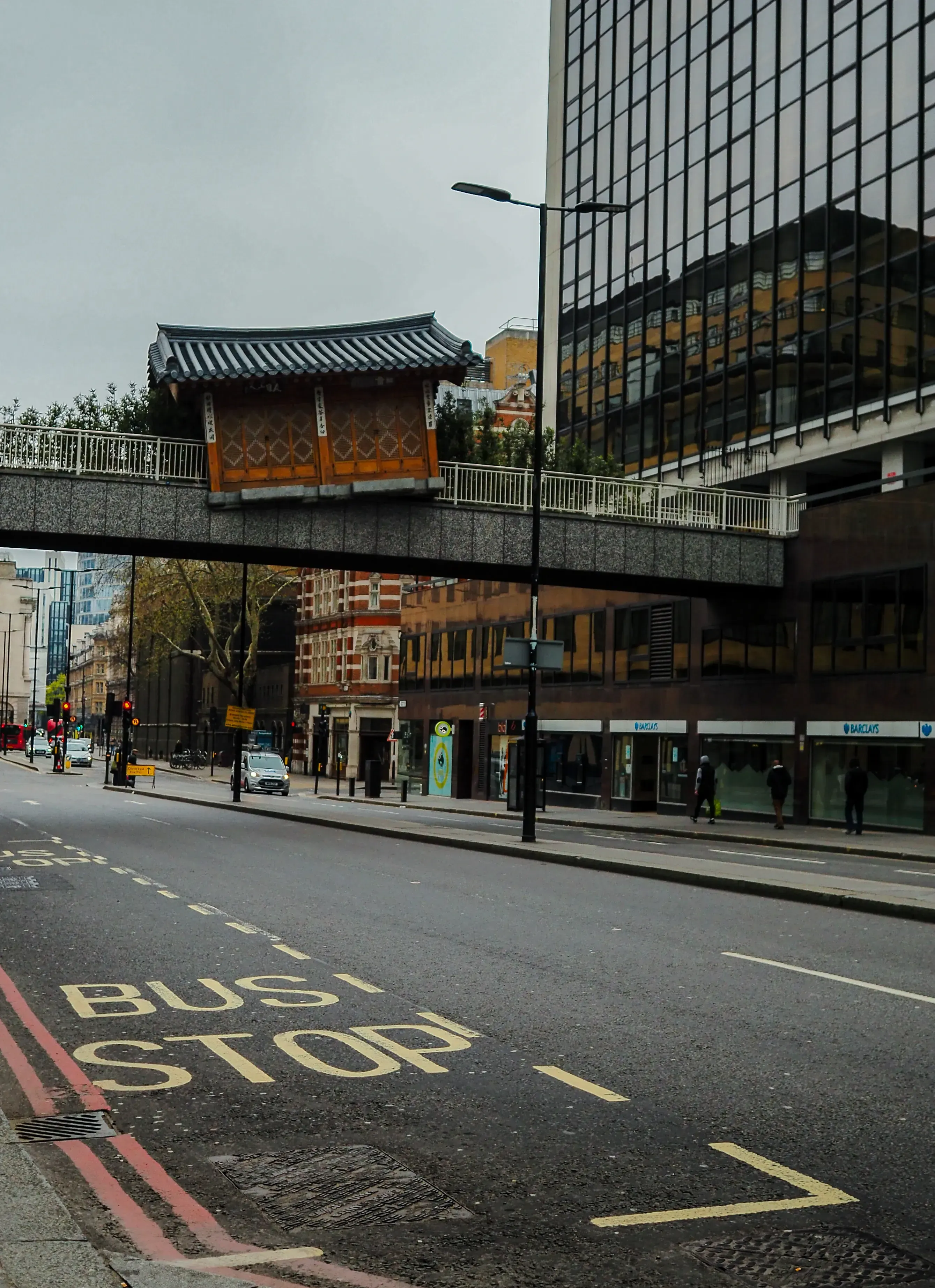 View of a very narrow or unusually shaped Japanese-style house wedged between larger buildings in London.