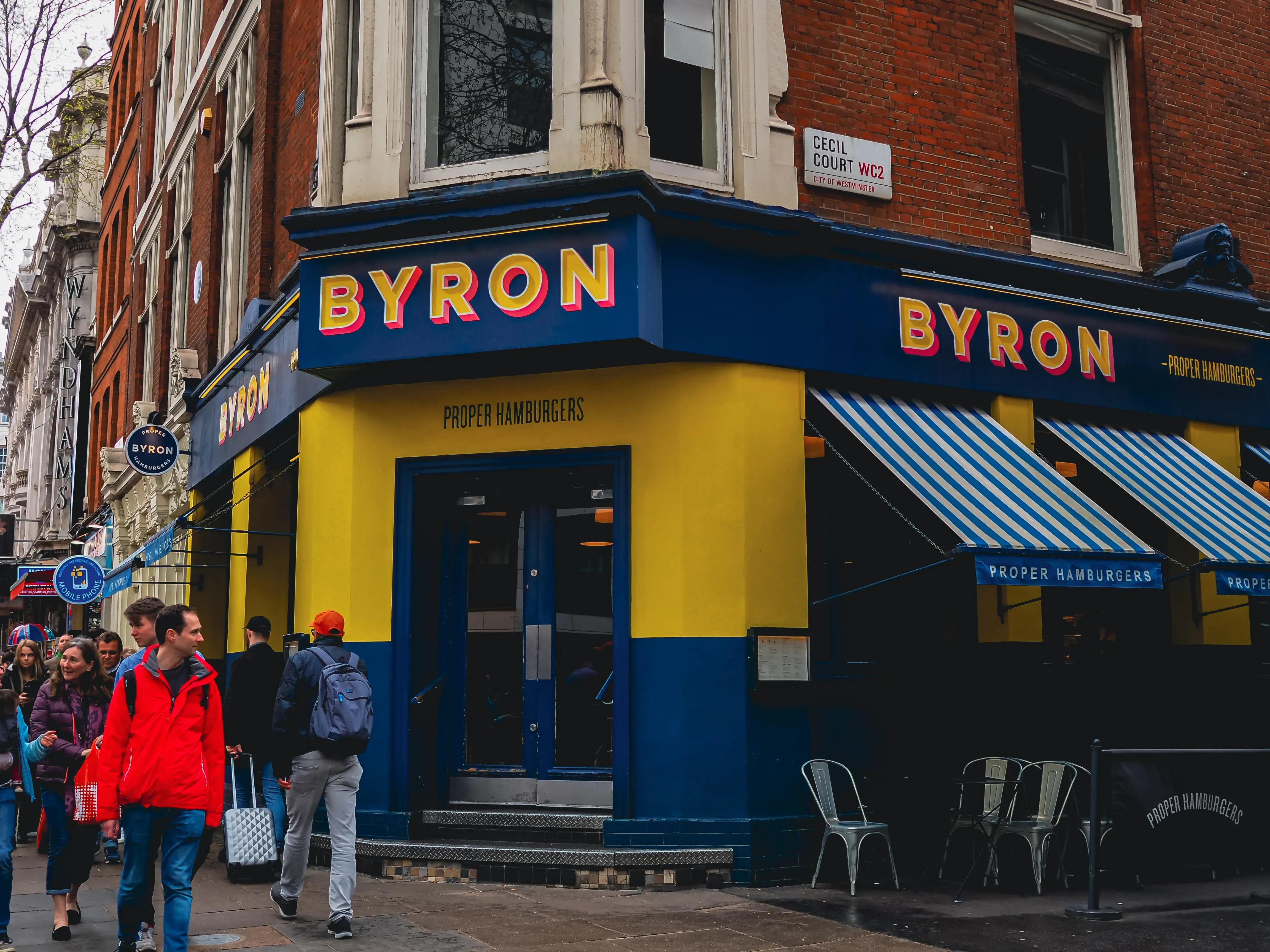 Exterior of the Byron restaurant with its recognizable yellow and blue branding.