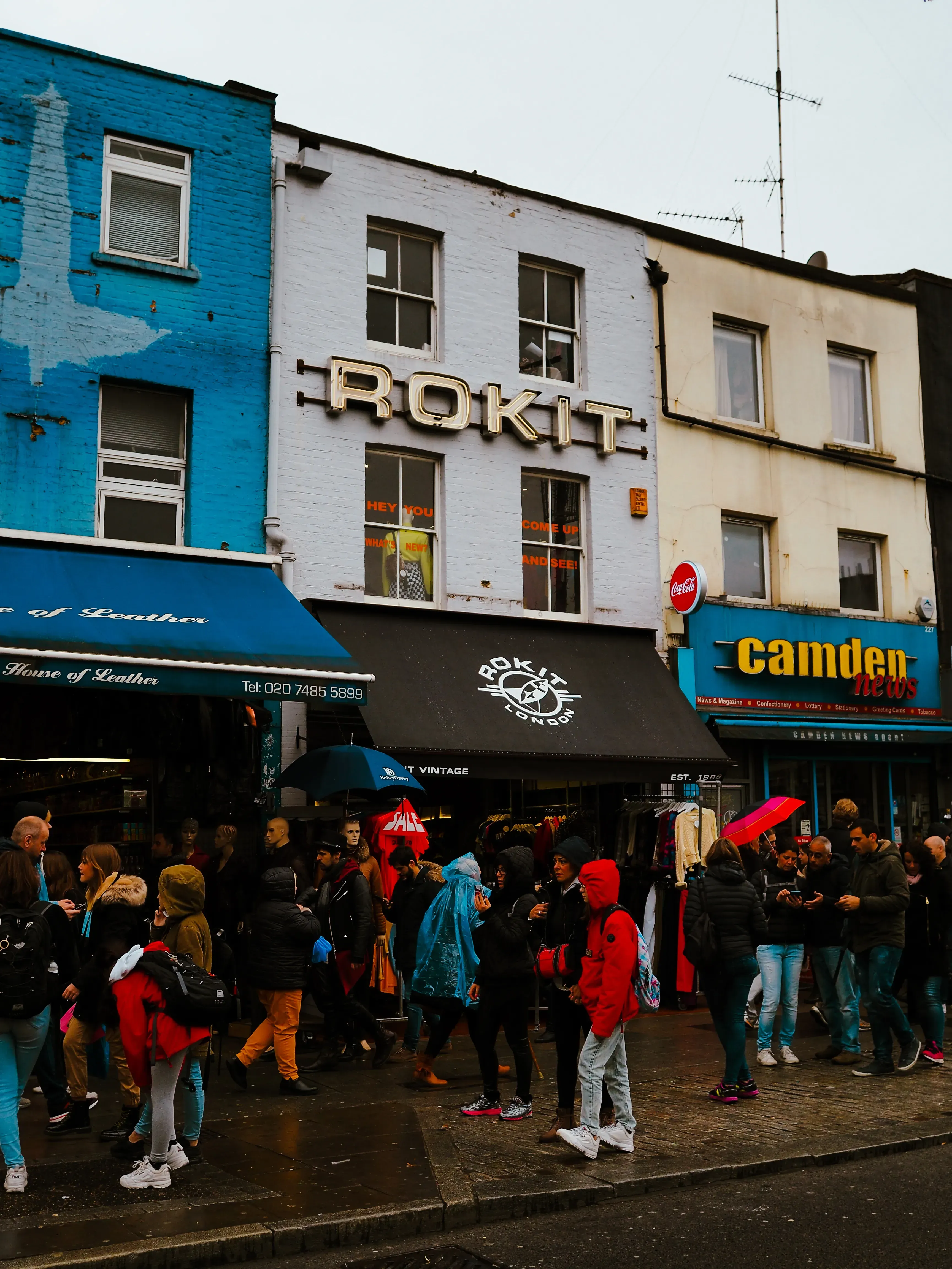 A colorful and eclectic street scene showing the unique storefronts and signs of Camden Town market.