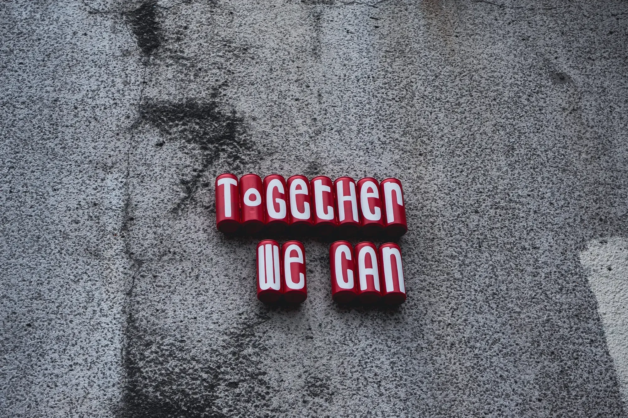Artwork formed by a collection of stacked or falling spray paint cansin graffiti style.