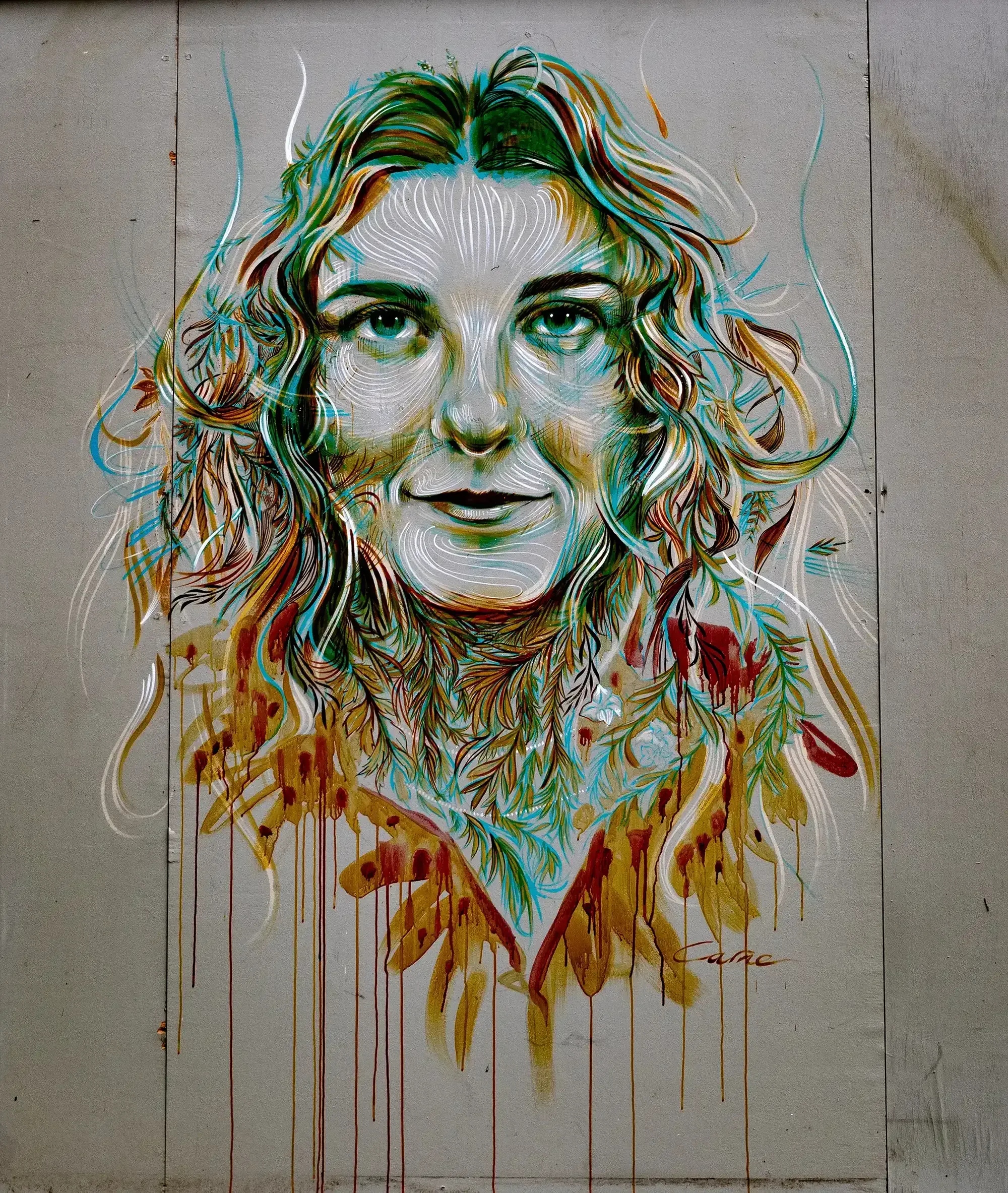 Detailed graffiti mural portraying the face of a woman.