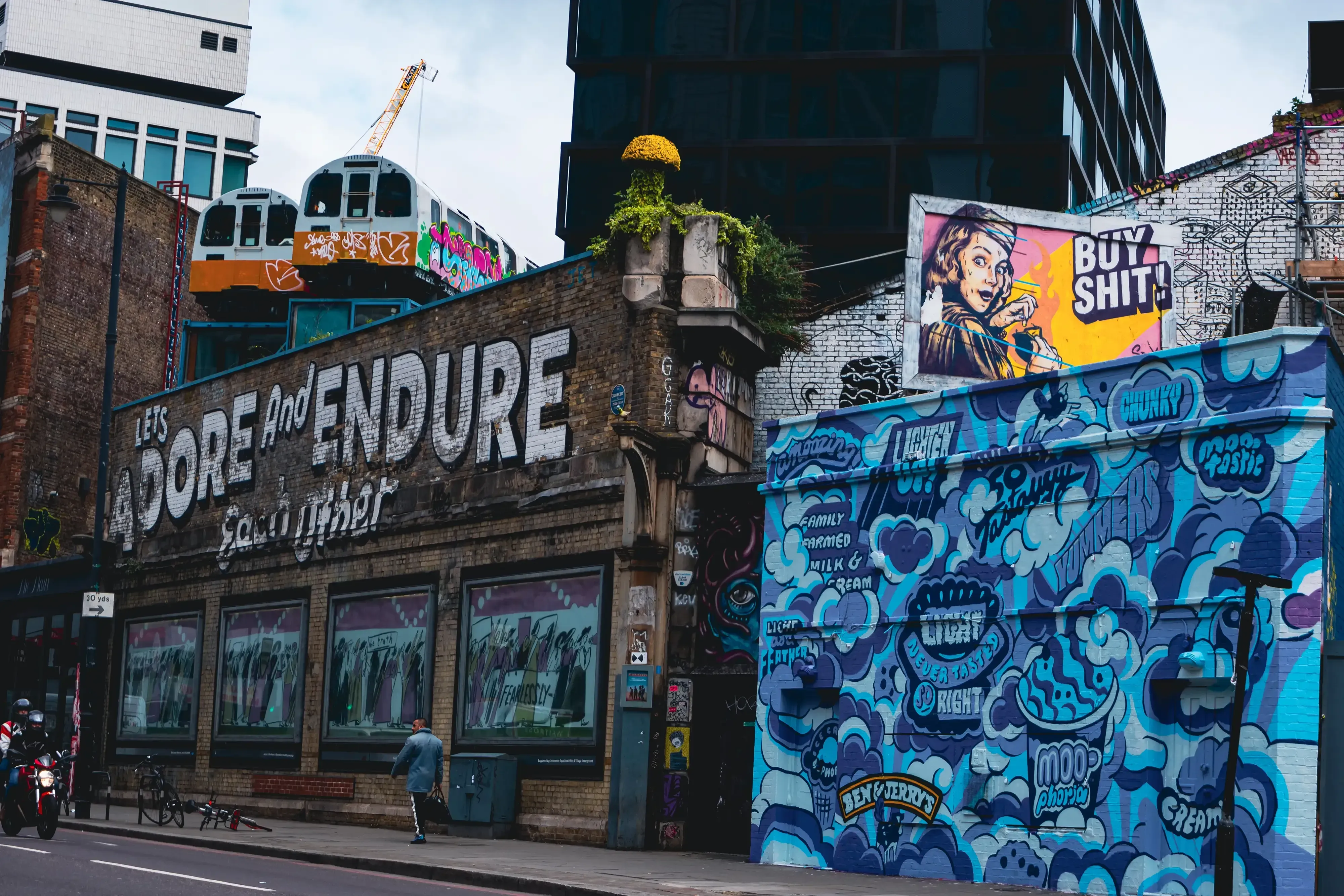 A dense collection of street art and colorful wall paintings in an urban setting.
