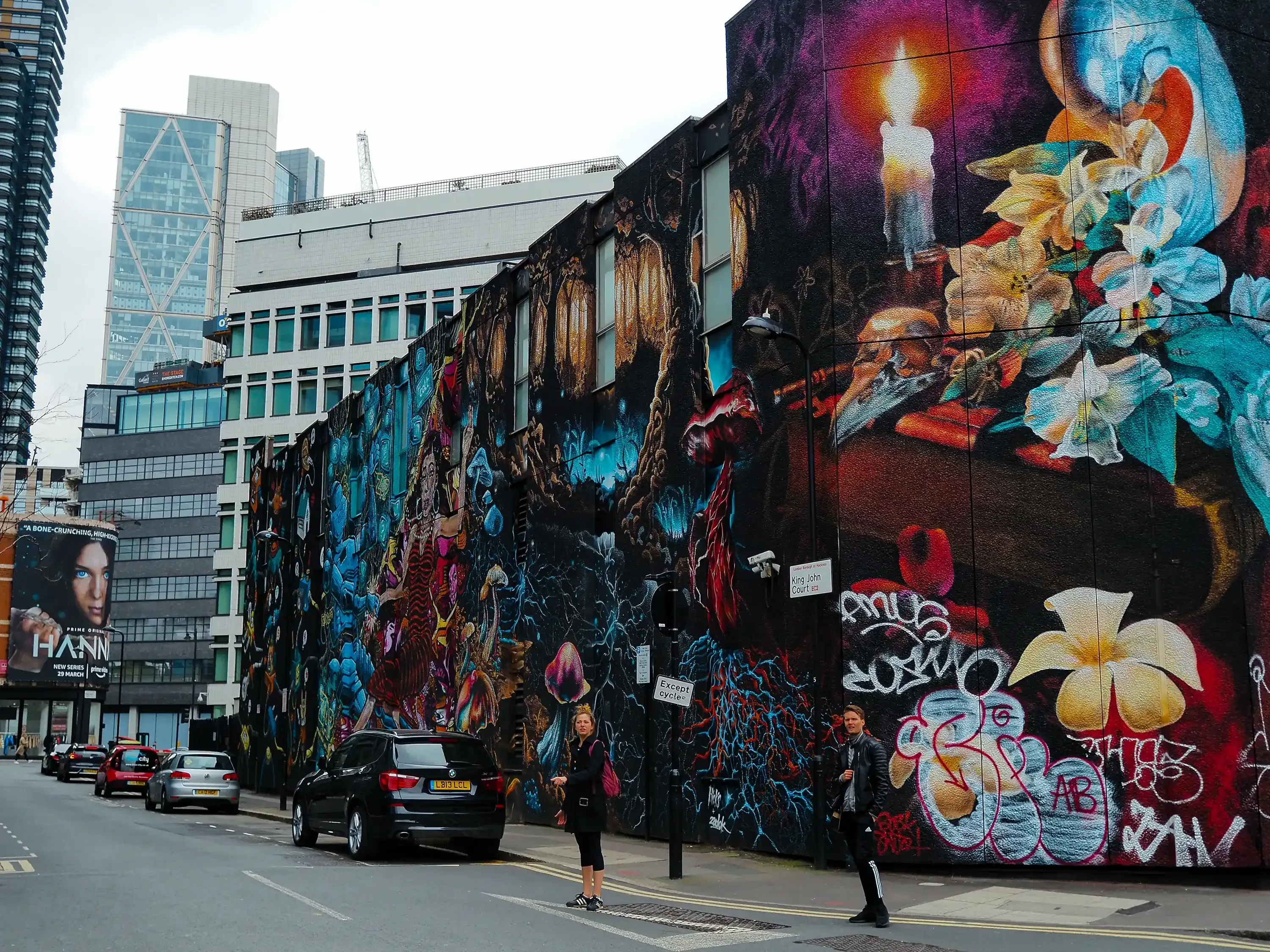 Another section of wall covered with varied tags and artistic graffiti pieces.