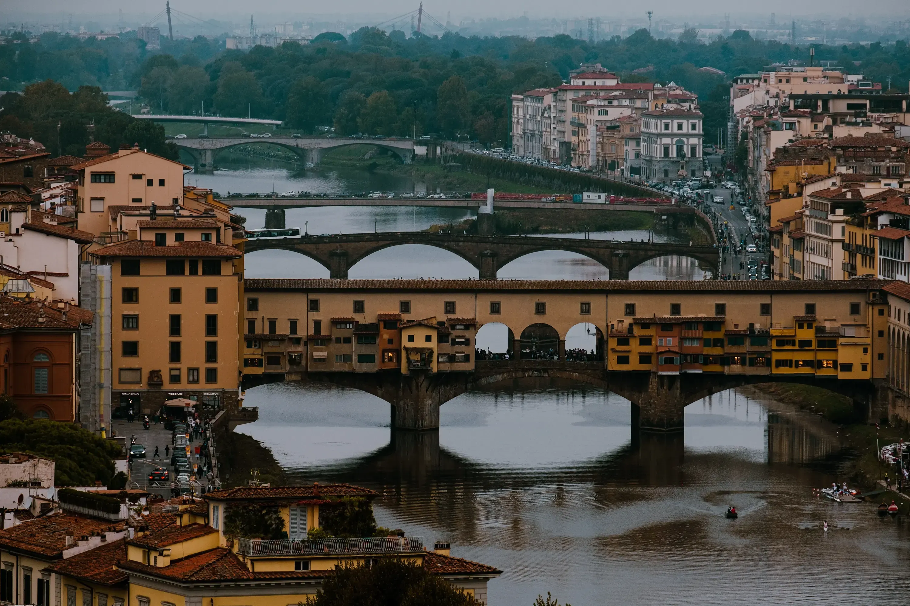The iconic Ponte Vecchio bridge in Florence, lined with ancient shops and structures.
