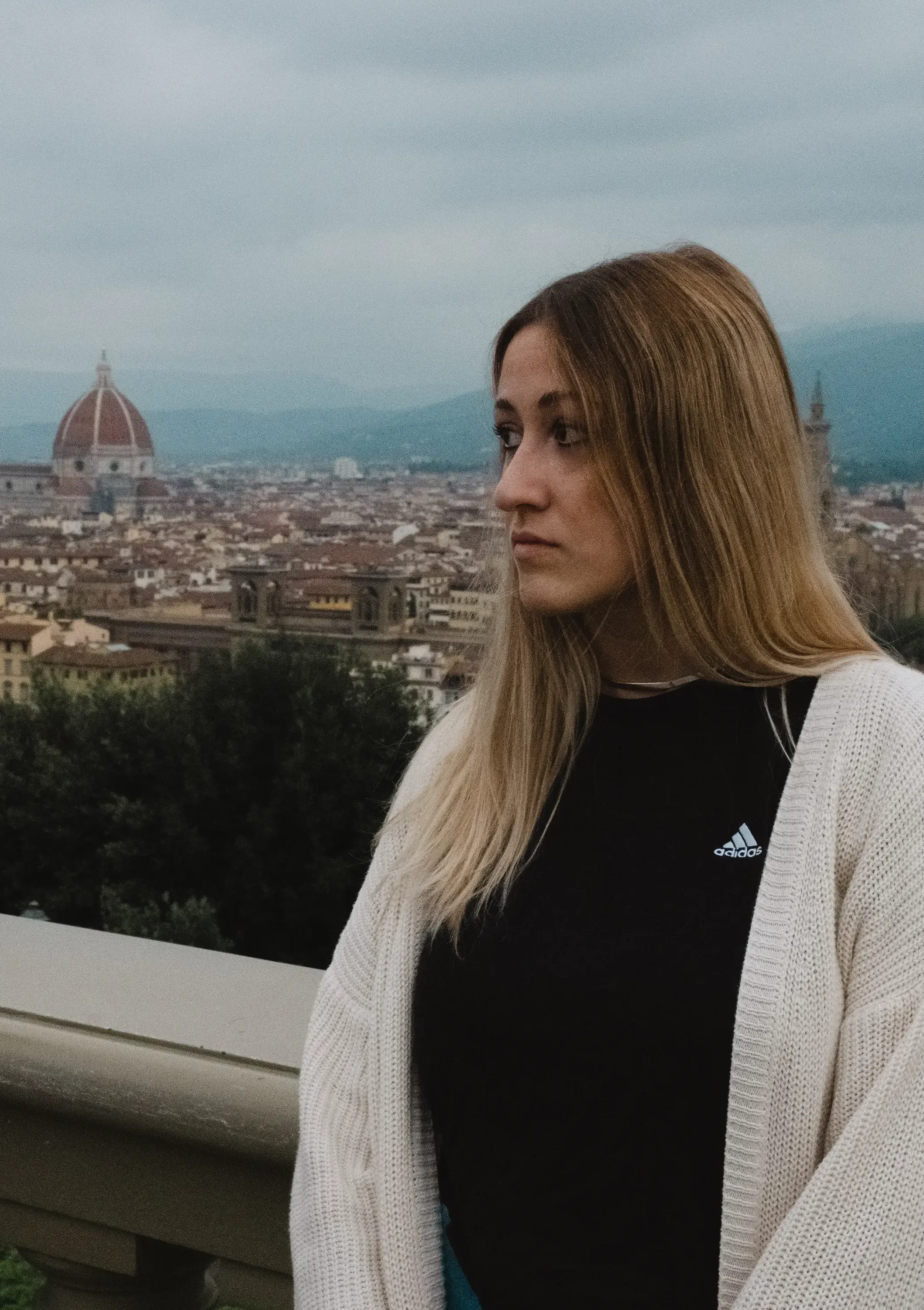 Letizia looking around while standing with of the Florence Duomo in the background