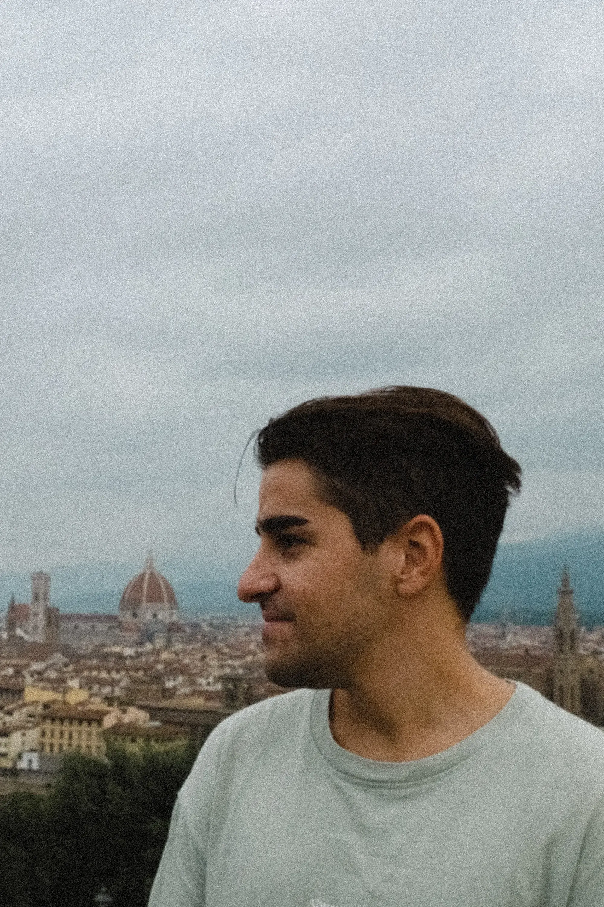 Ieser standing with the large facade and dome of the Florence Duomo in the background.