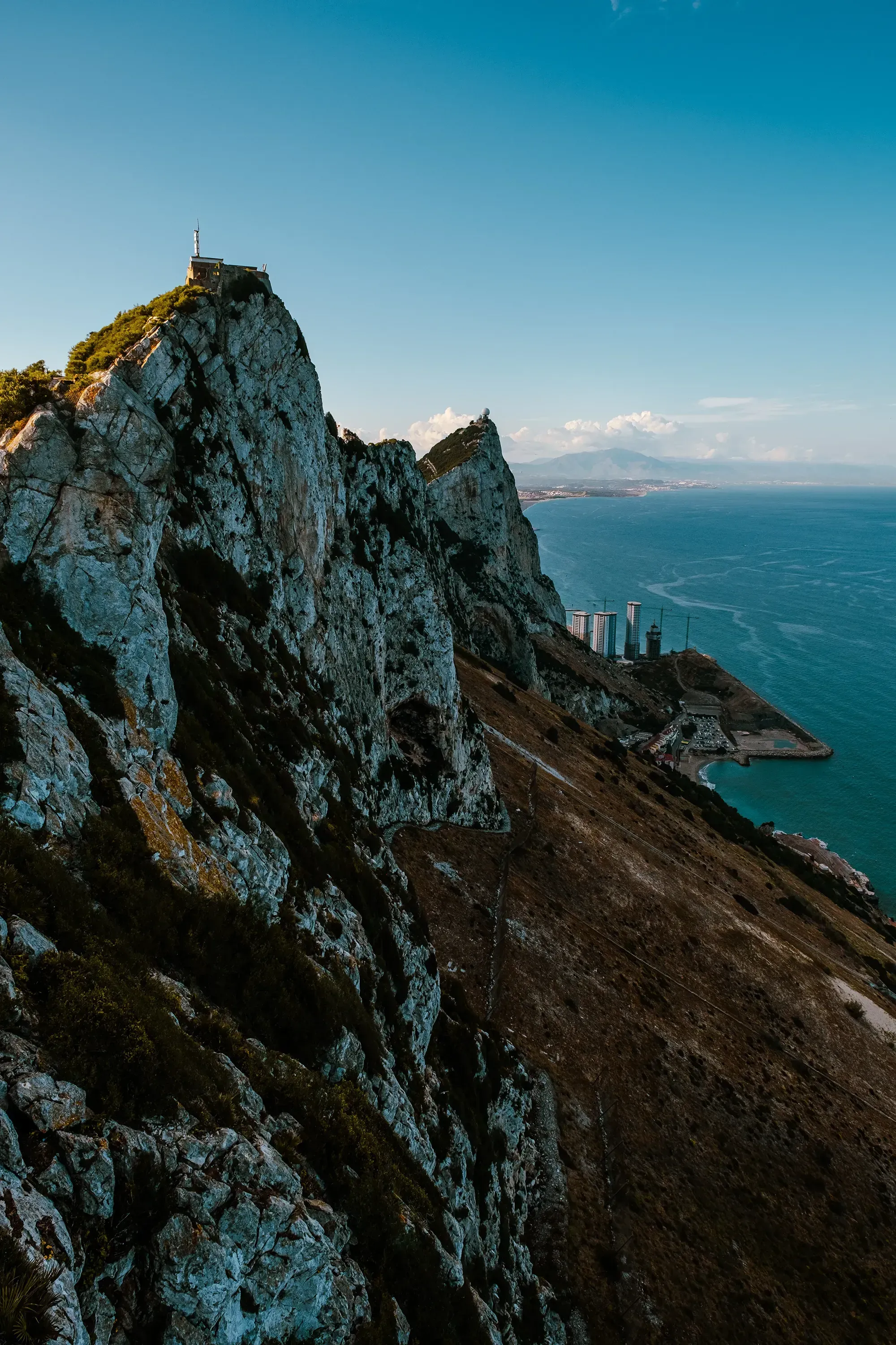 The massive, iconic limestone monolith of the Rock of Gibraltar rising dramatically from the surrounding landscape.