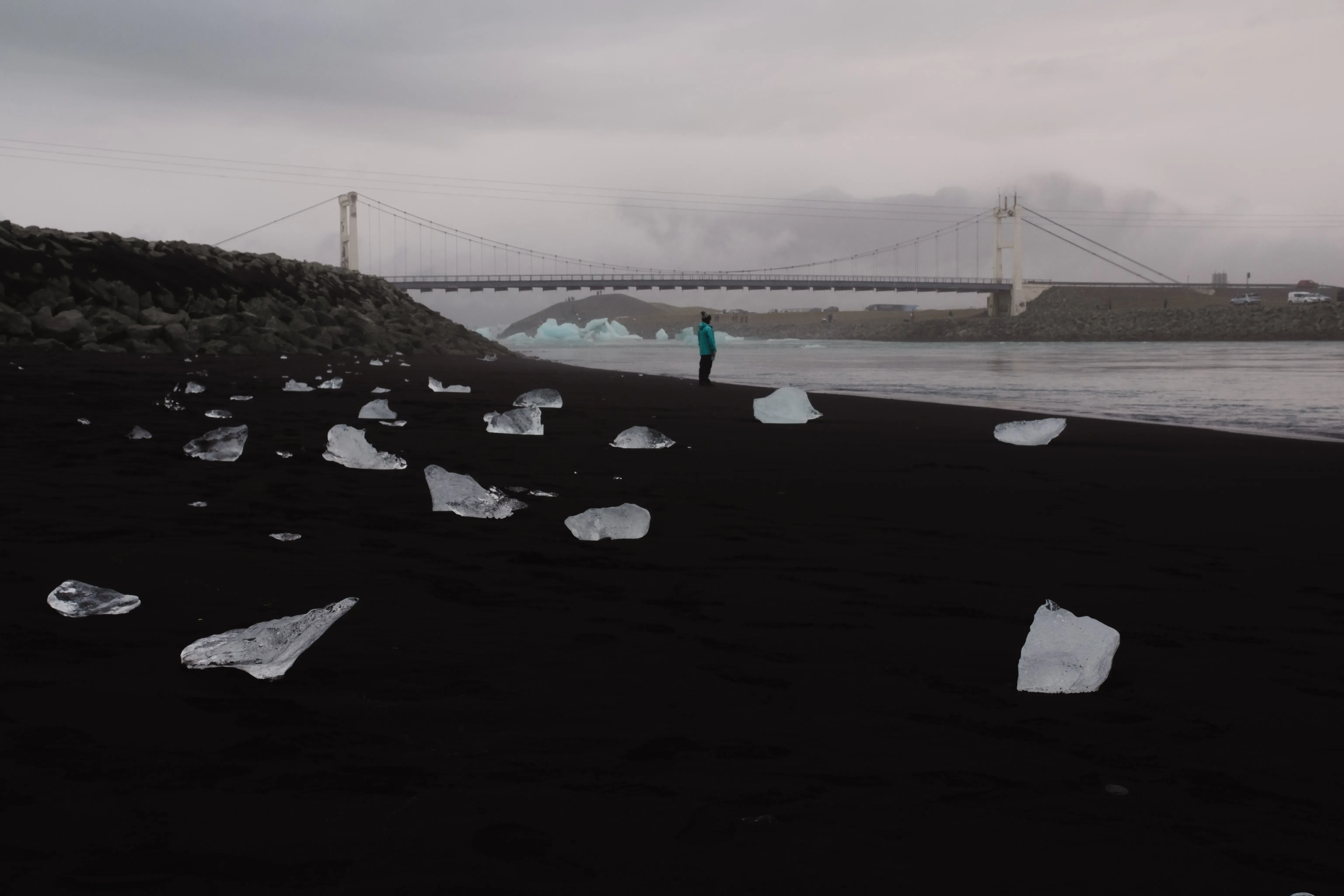 A bridge spanning the river mouth that connects Jökulsárlón glacier lagoon to the ocean near Diamond Beach.