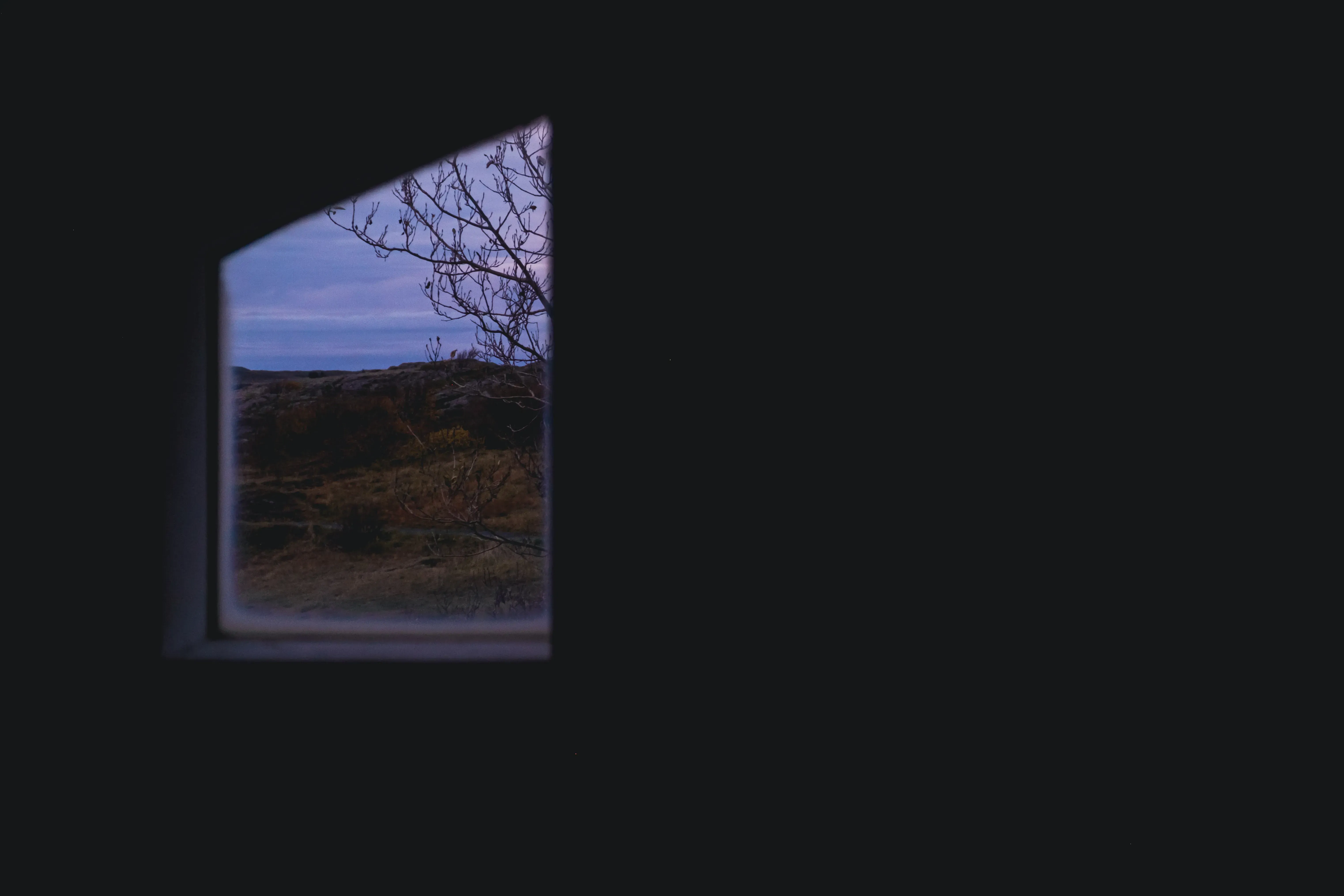 View of the vast, rugged Icelandic countryside framed by a window.