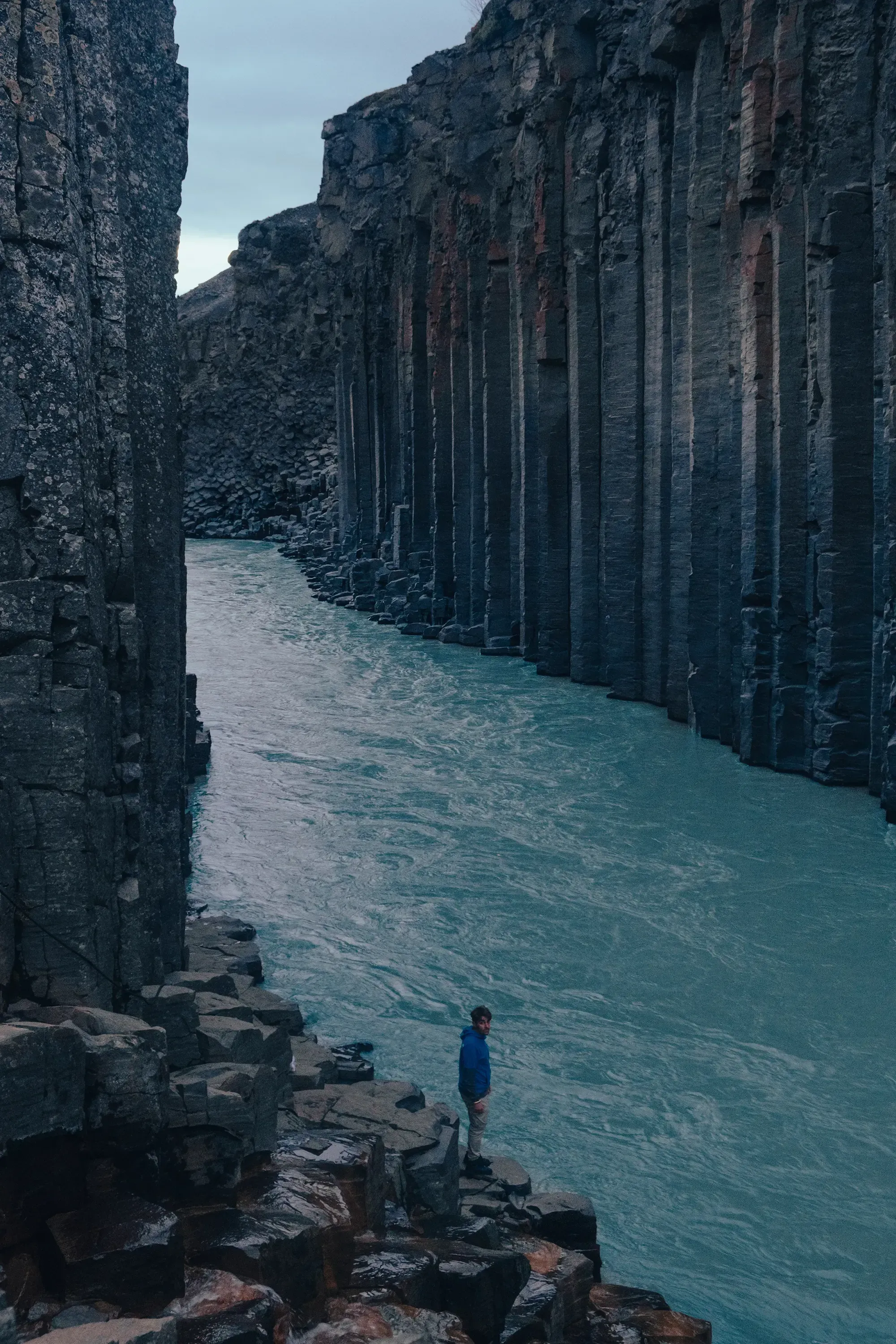The famous Studlagil canyon with basalt column with geometric, hexagonal rock formations.