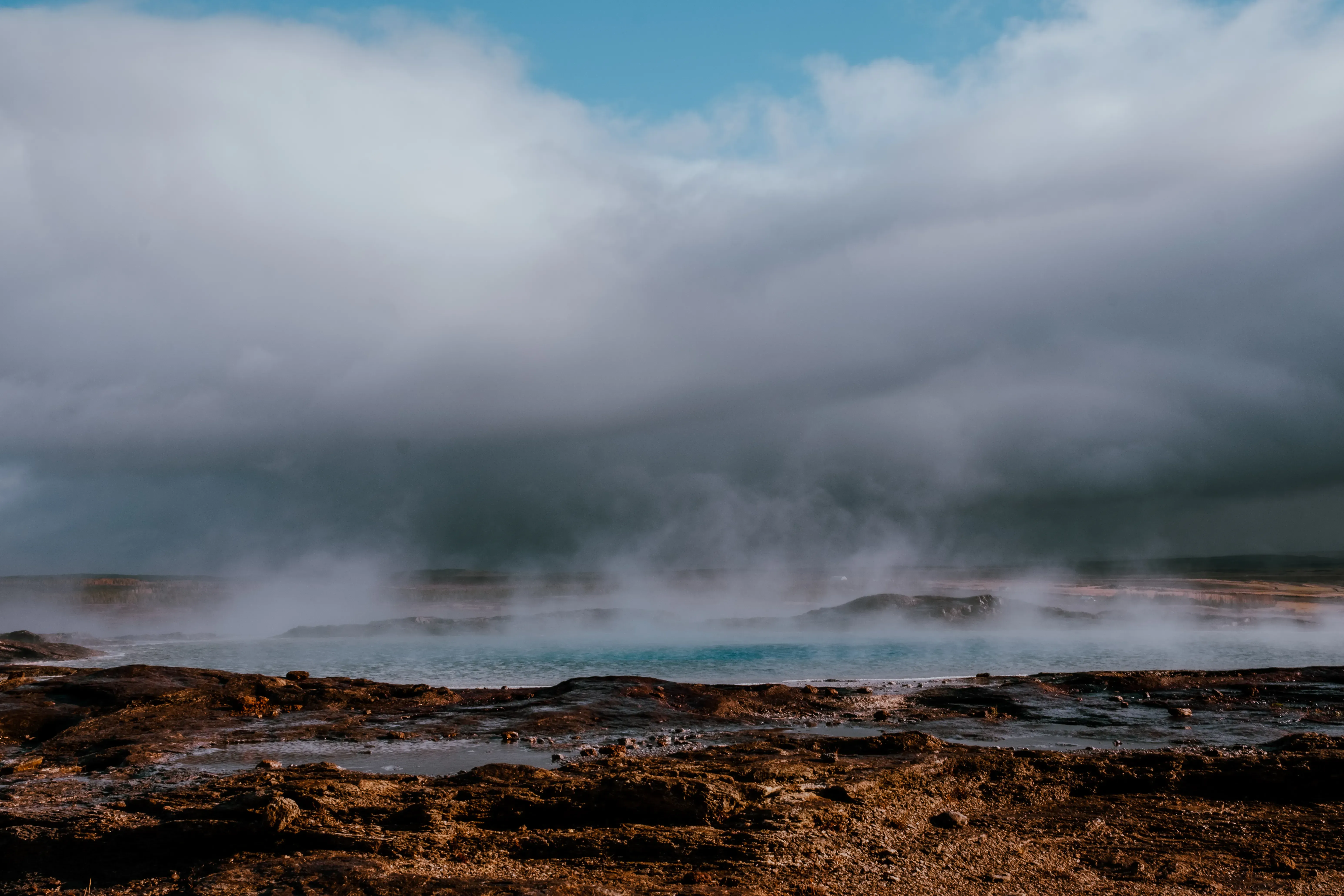 The pool of water and bubbles (the dome) of a geyser (like Strokkur) just before its explosive eruption.