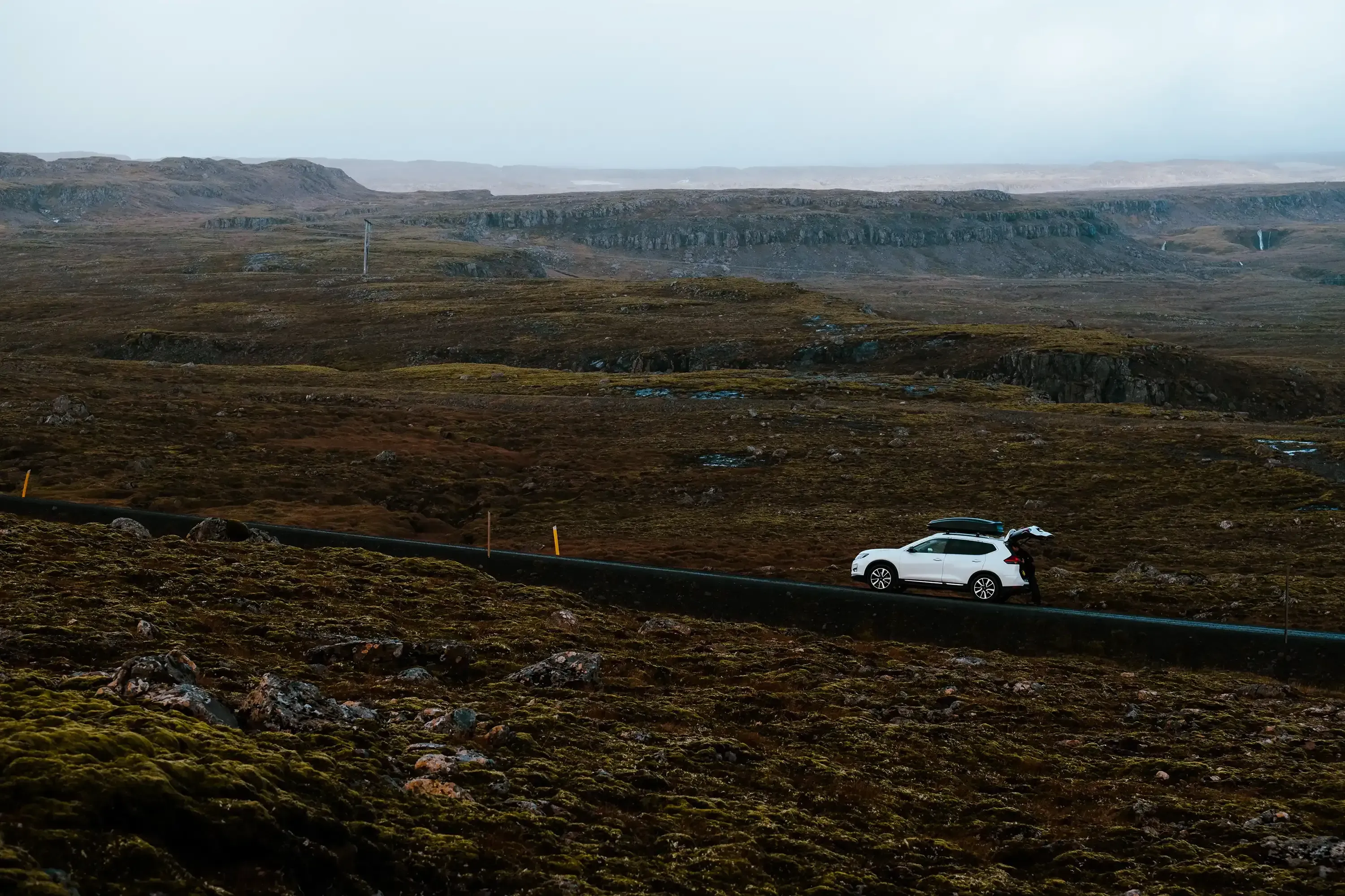 Our car parked on the shoulder of a scenic Icelandic road.