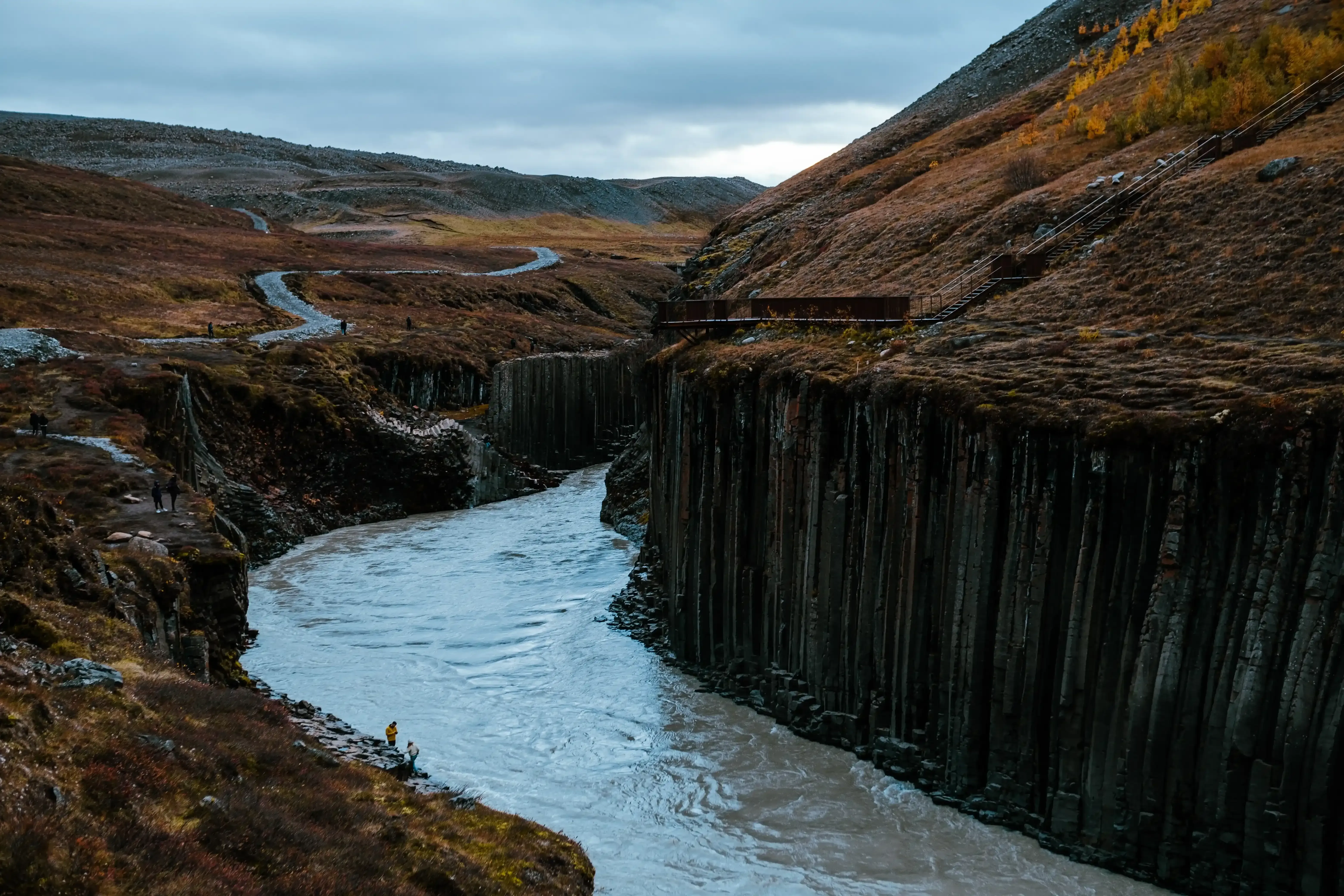 The bright turquoise river (Jökla or Jökulsá á Dal) flowing through the bottom of Stuðlagil Canyon.