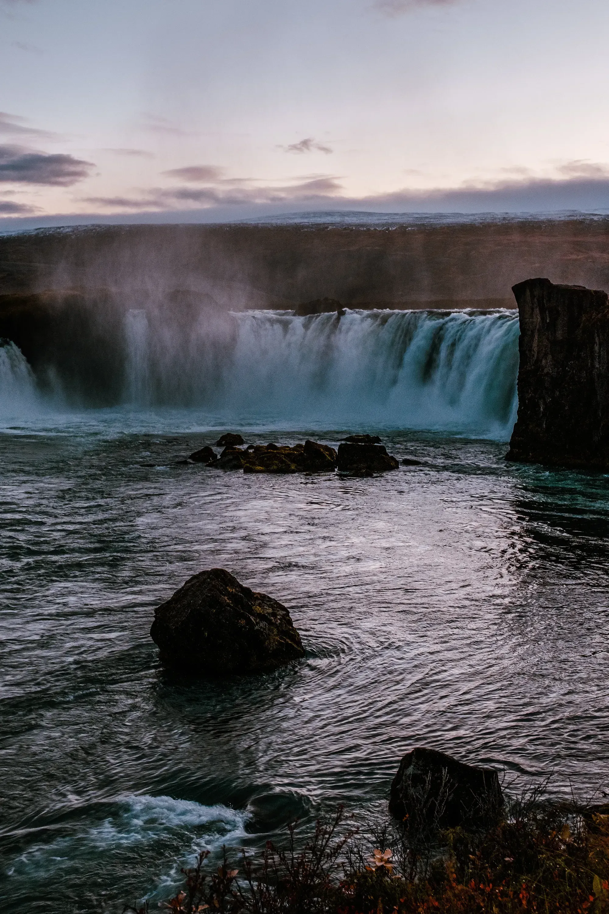 The wide, semi-circular waterfall of Godafoss known for its horseshoe shape.