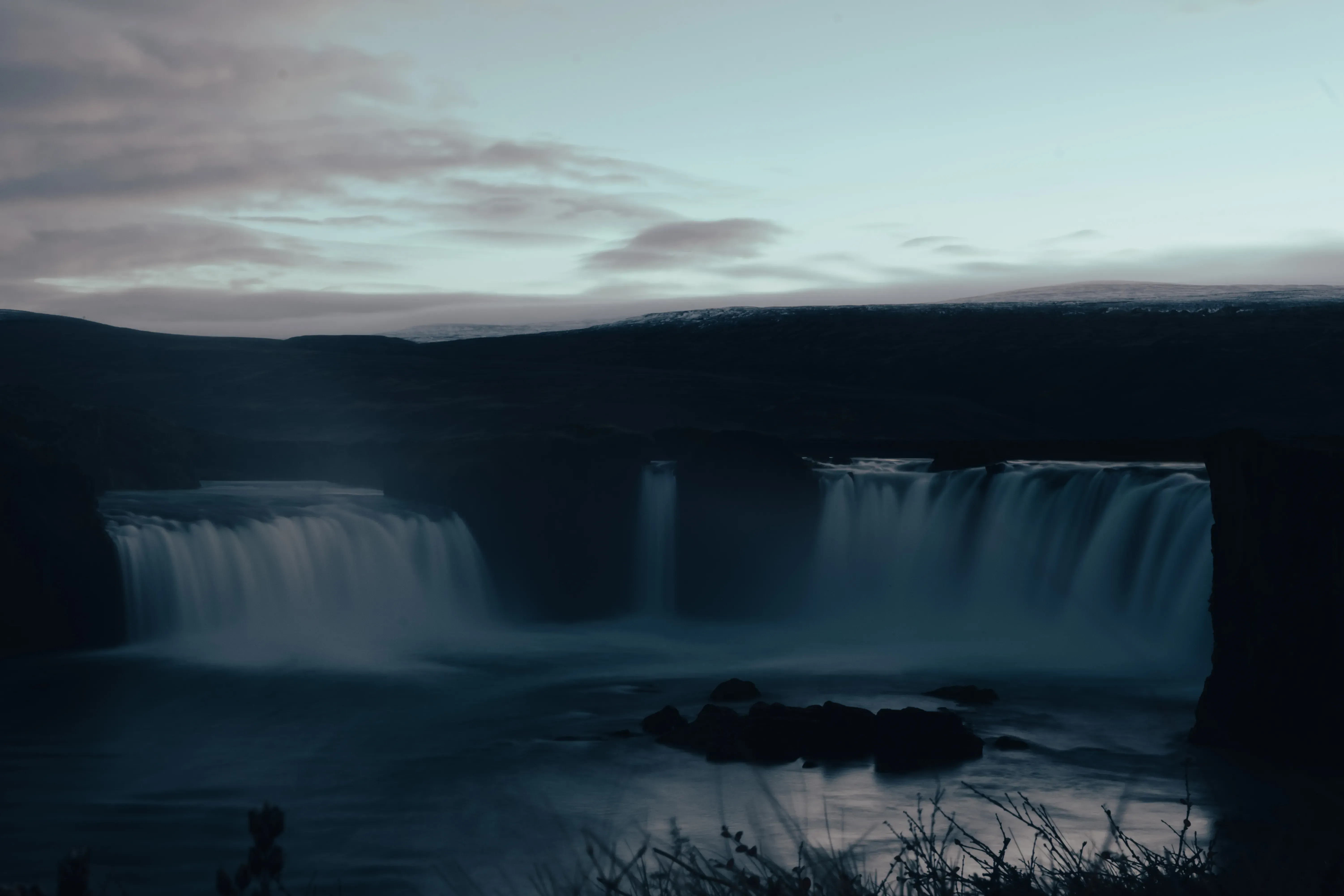 The Godafoss waterfall illuminated or viewed under the fading light of evening or twilight.