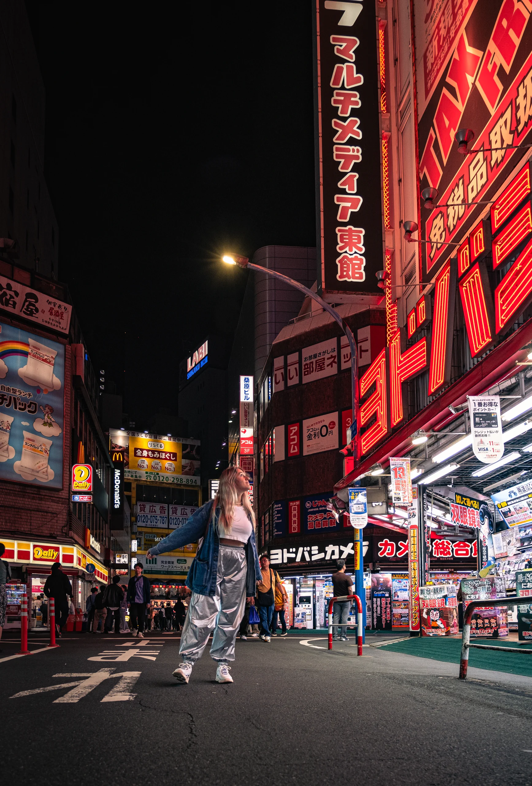 Letizia standing in the neon-lit streets of Shinjuku, Tokyo, at nigh