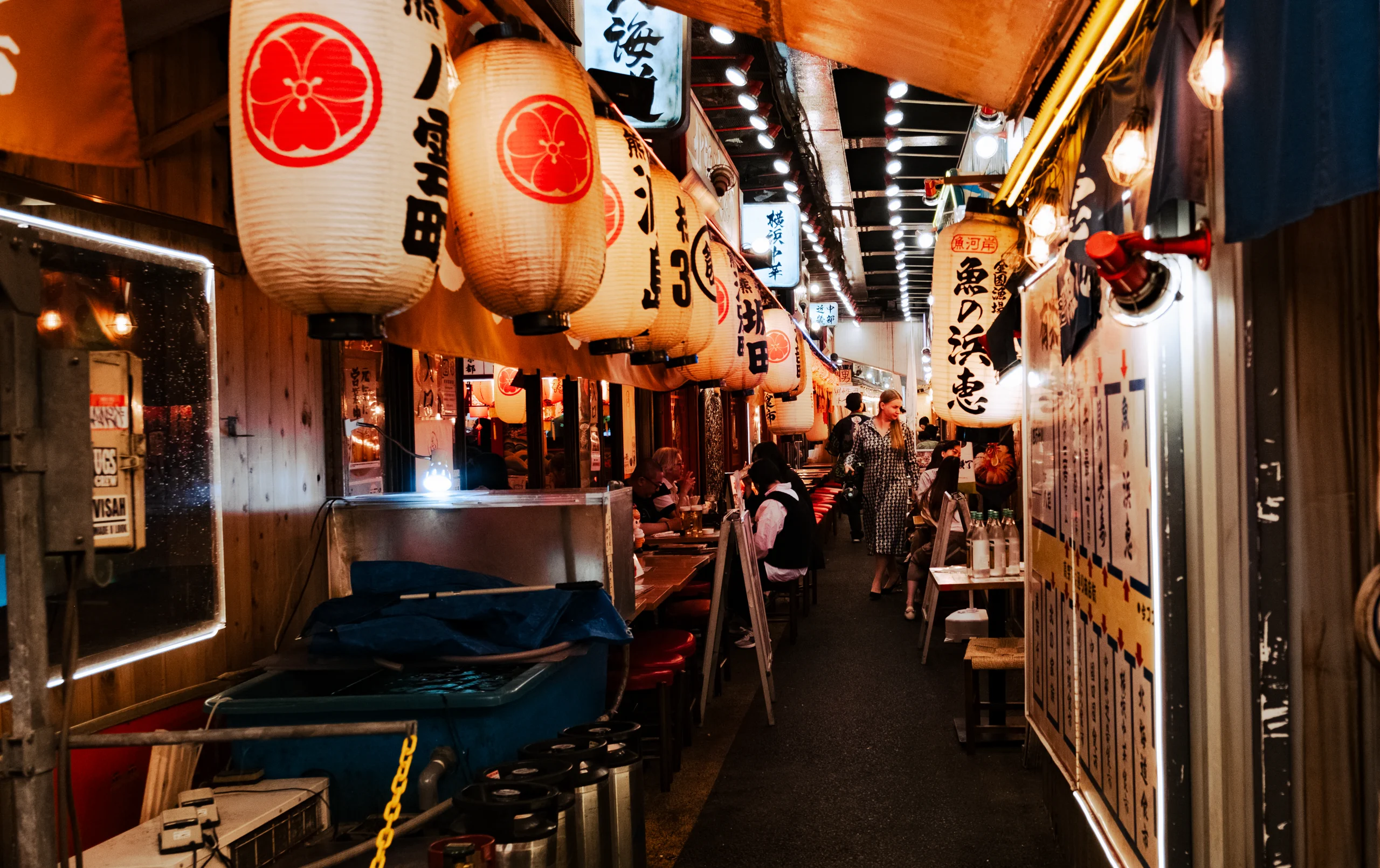 Crowded narrow streets and food stalls at the Tsukiji Outer Market in Tokyo