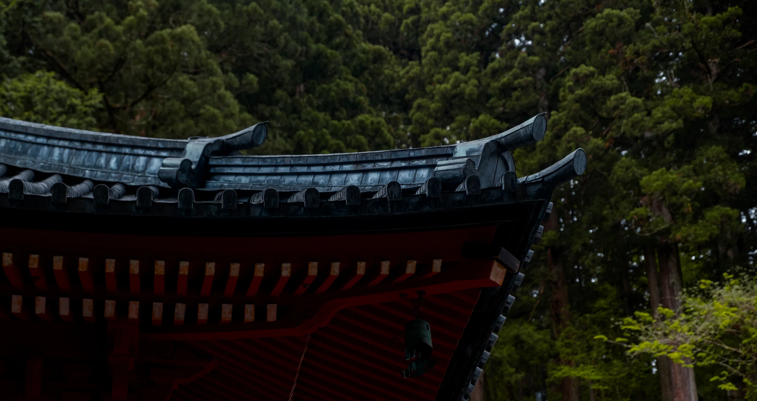 Detailed architecture and colorful carvings under the eaves of a temple roof in Nikko Toshogu Shrine