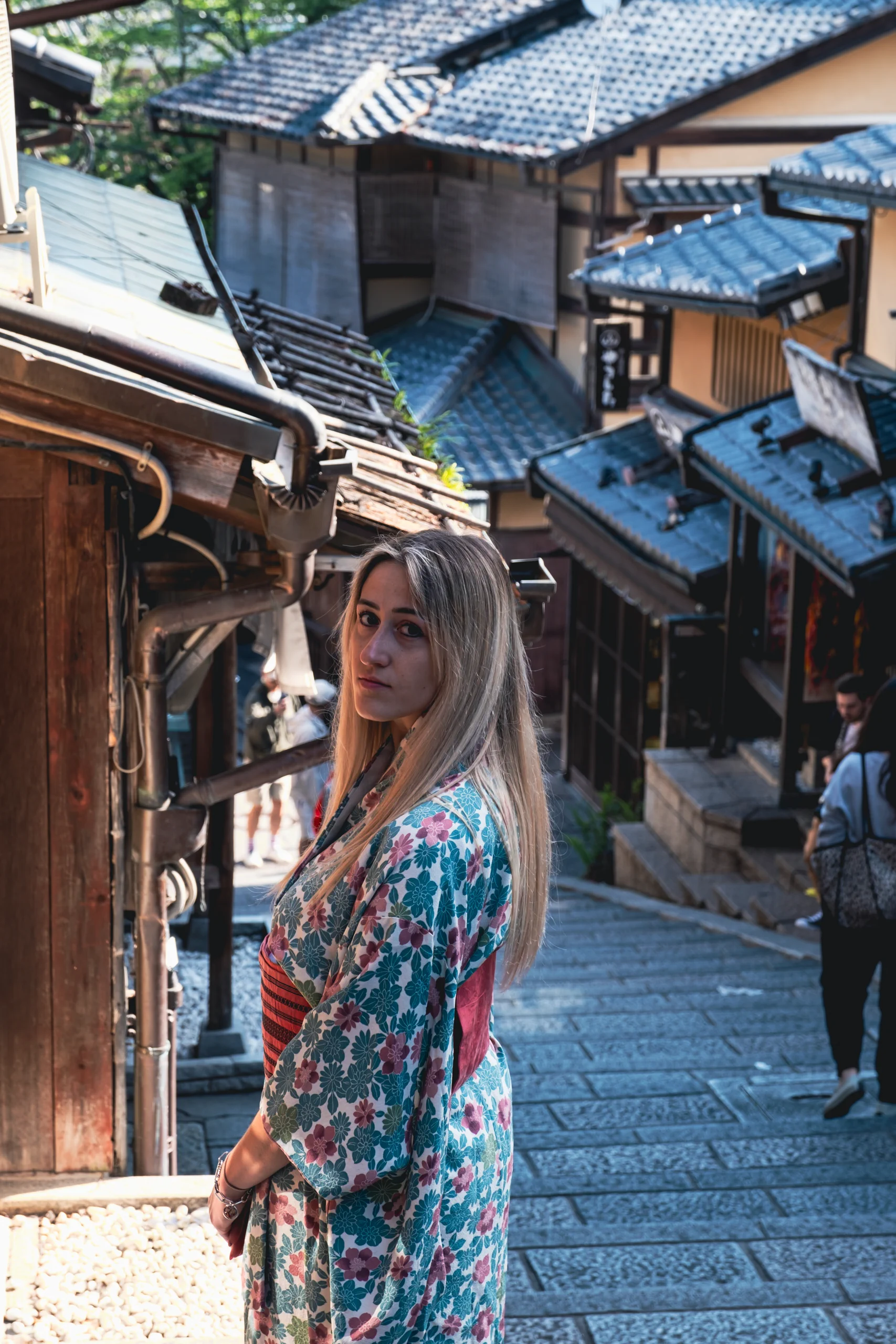 Letizia walking through the traditional streets of Kyoto in a kimono