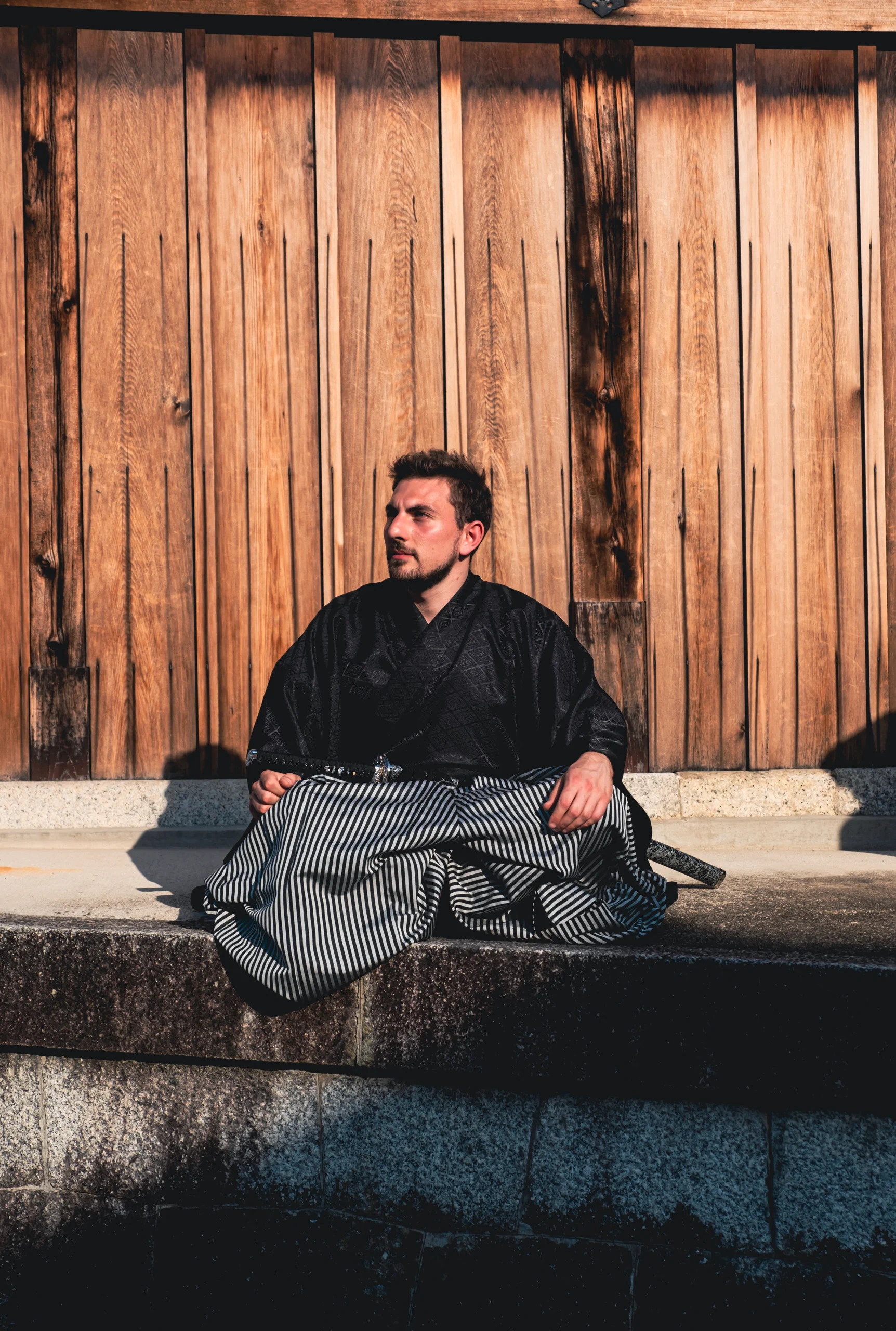 Davide sitting while wearing a traditional samurai costume
