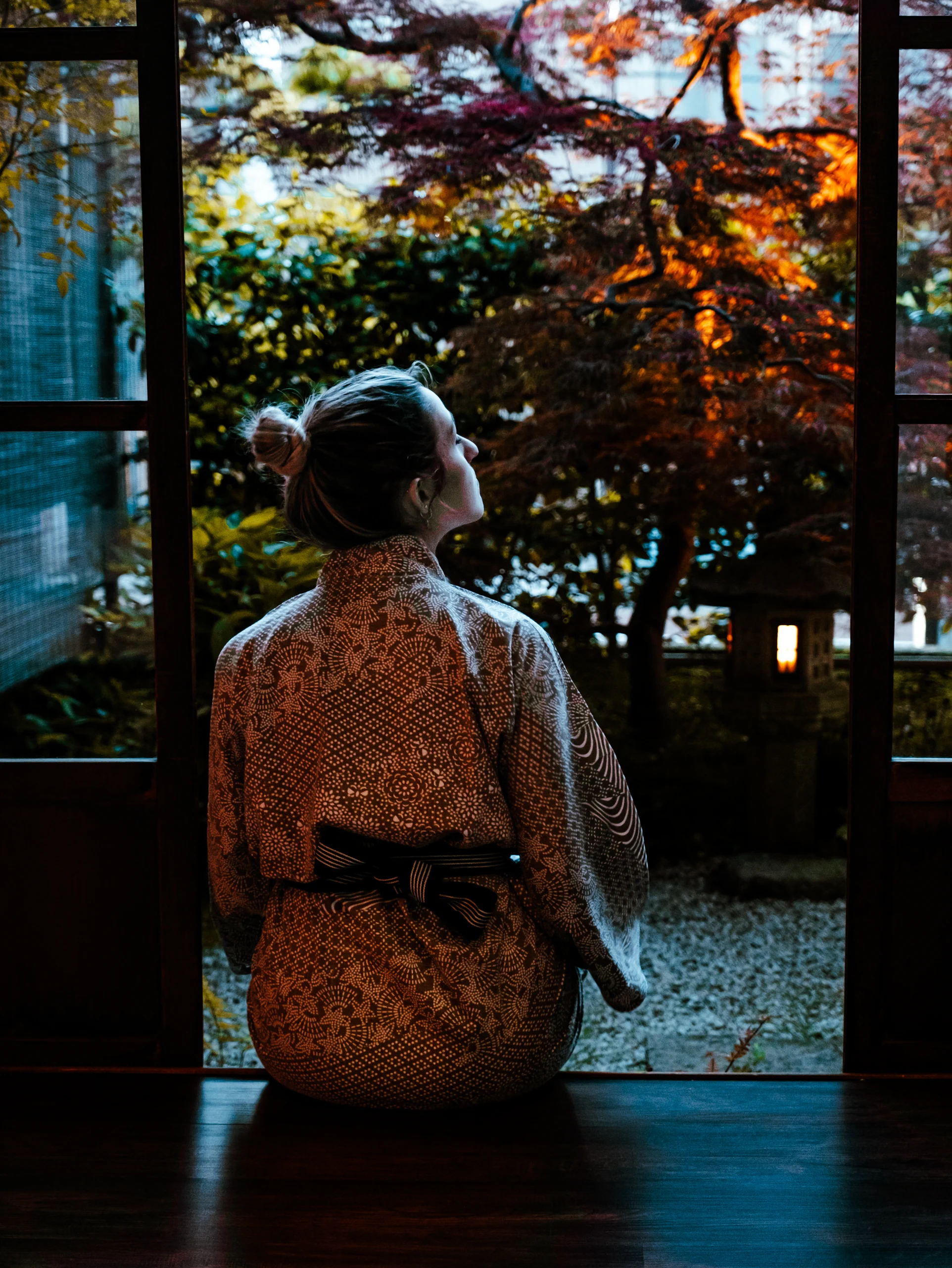 Letizia wearing a kimono looking out the window of a traditional Ryokan inn