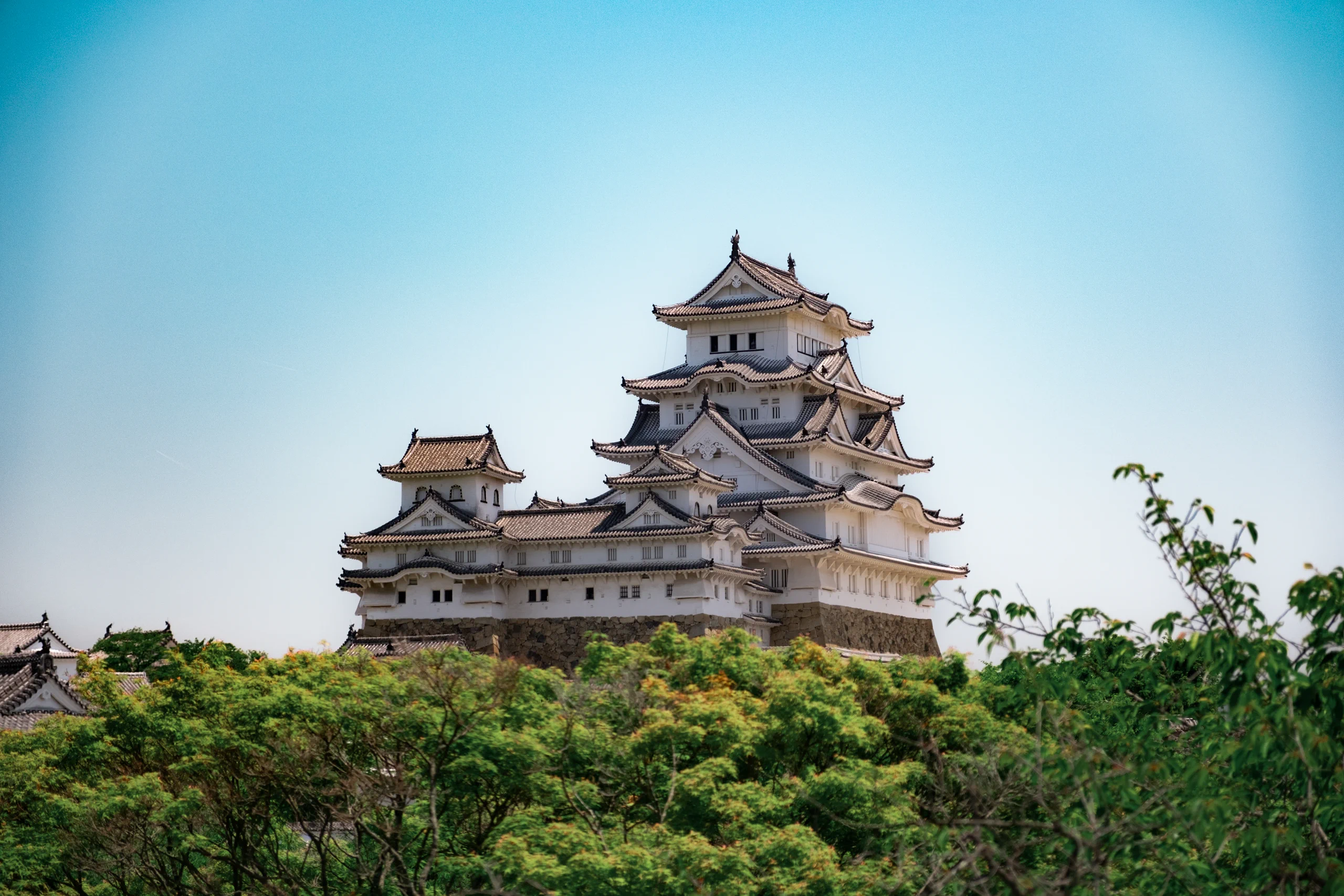 Himeji Castle, also known as the White Heron Castle, against a blue sky