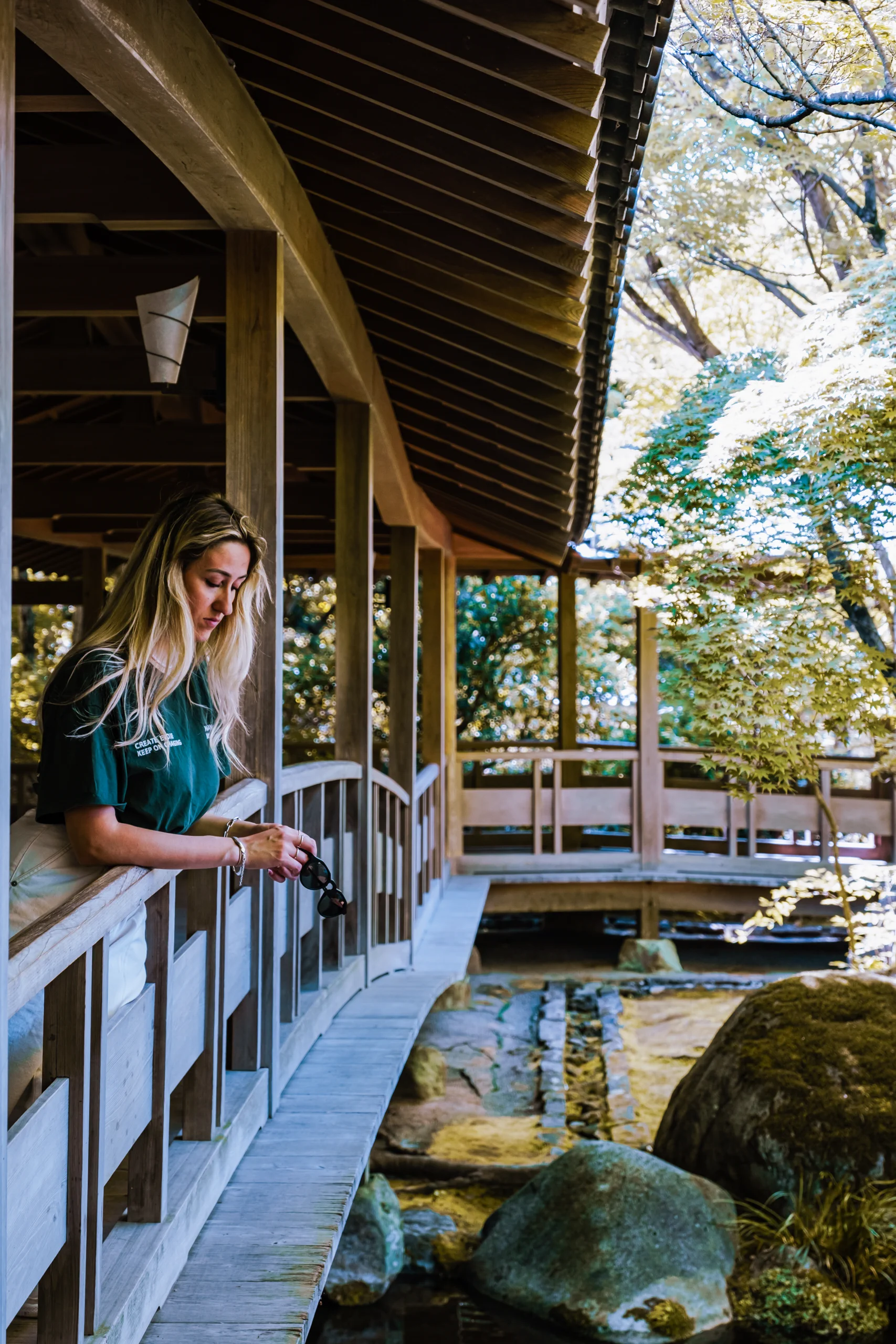 Letizia standing on a traditional wooden bridge in a Japanese garden
