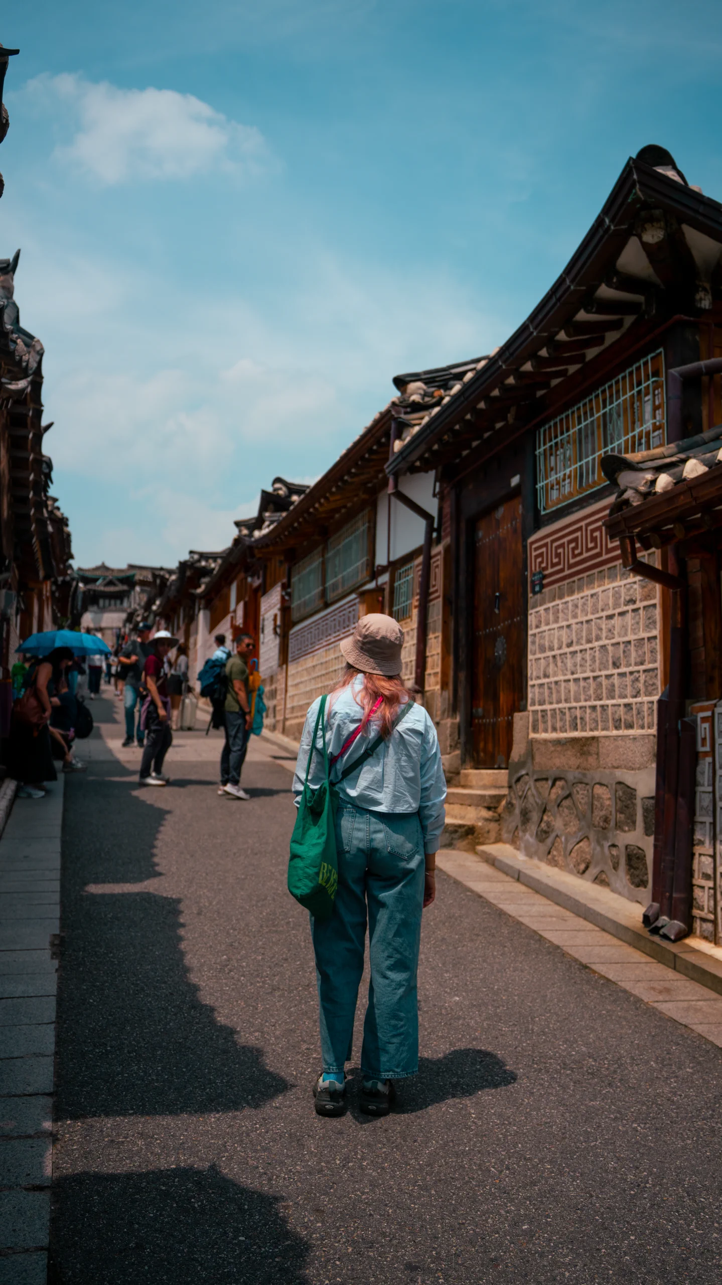 Letizia standing in the middle of a famous, bustling street or pedestrian area of Bukchon Hanok Village