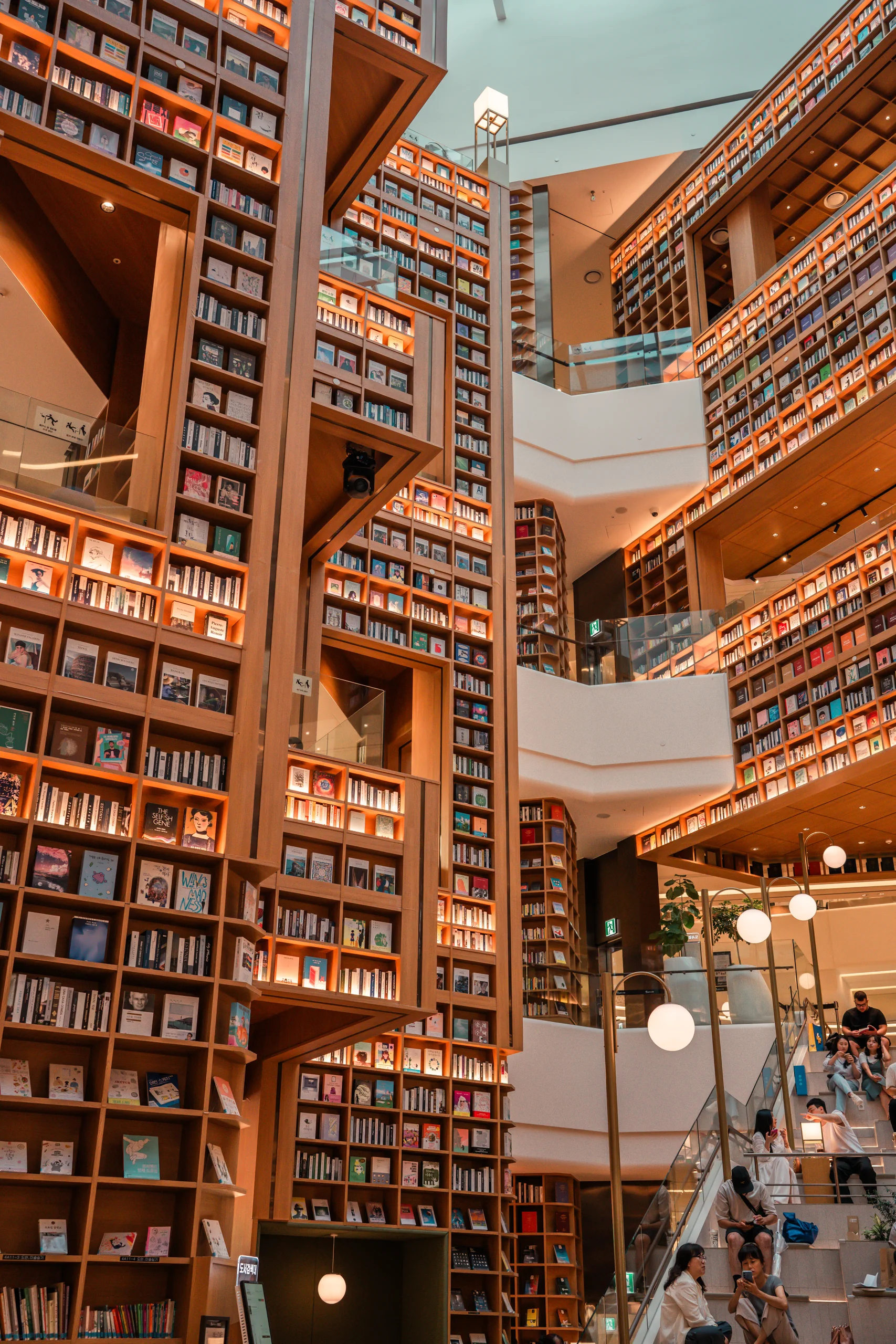 Close-up of the highly organized, brightly lit bookshelves in the Starfield Suwon Library.