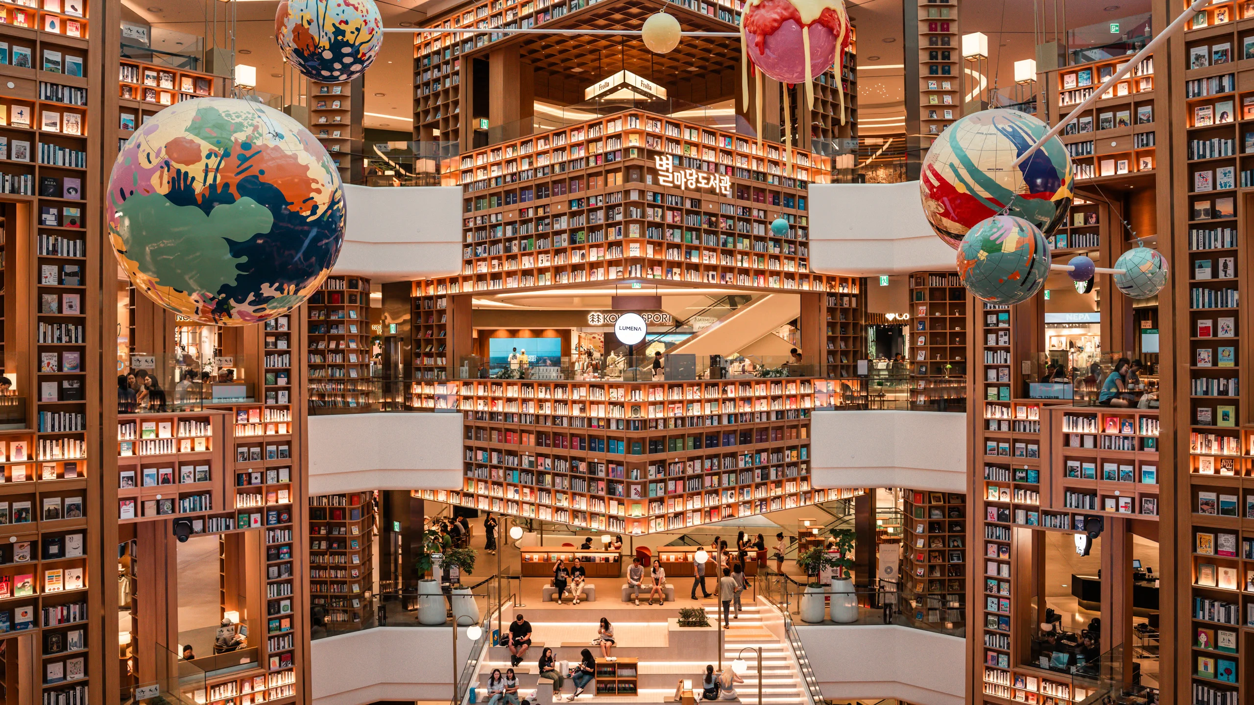 Broad aerial perspective of the vast Starfield Suwon Library interior, captured from an upper floor.