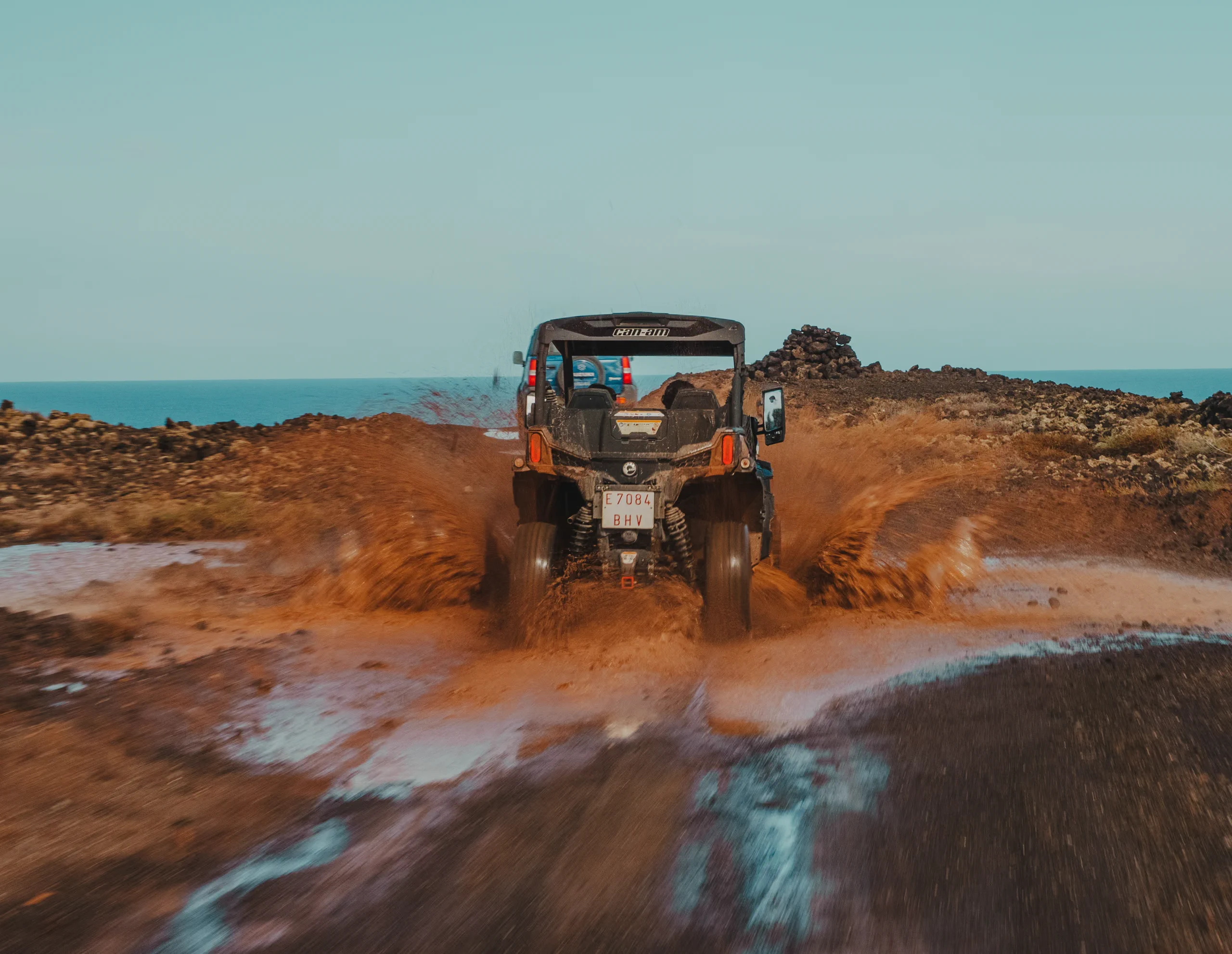 A buggie splashing through a puddle