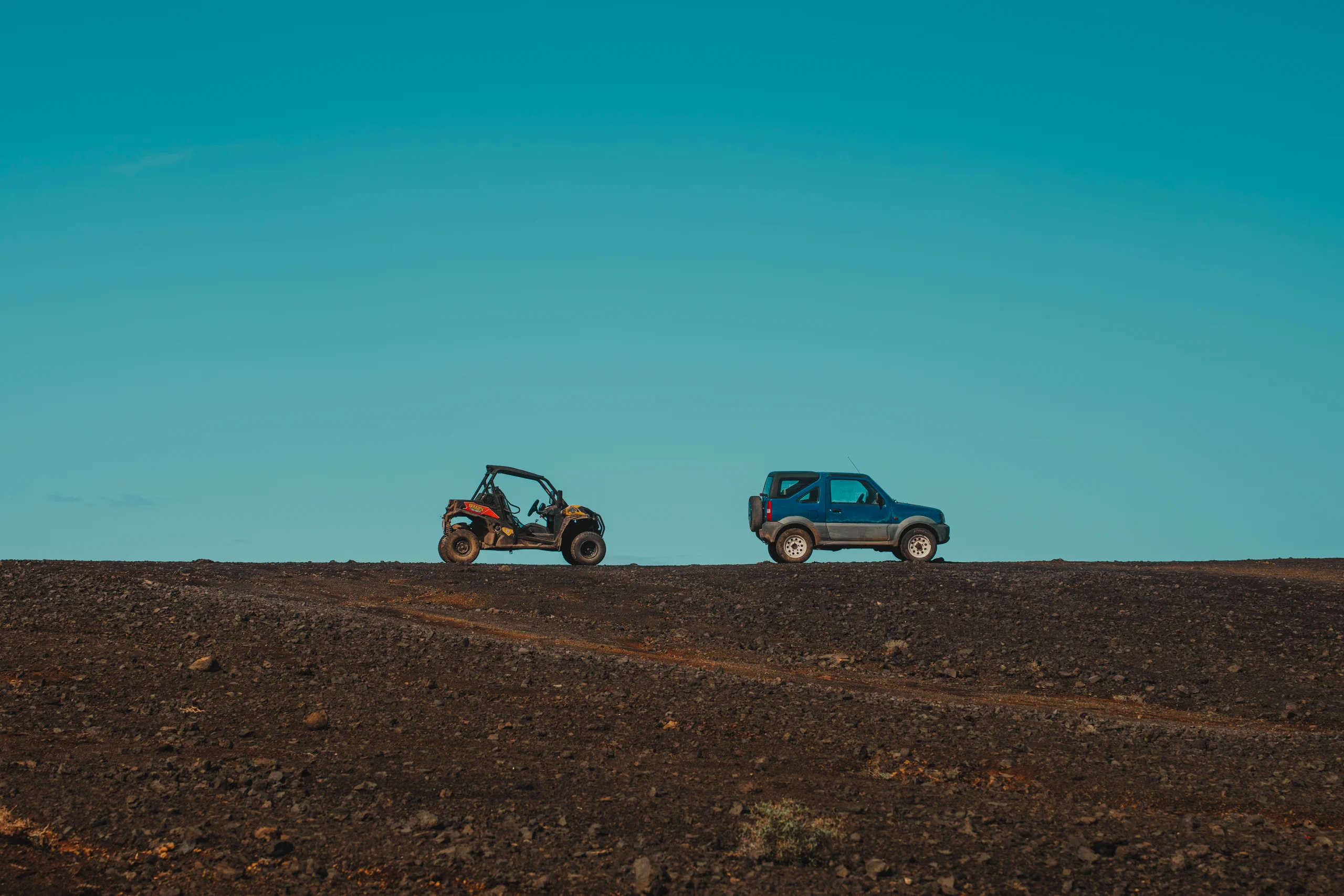 A Jeep and a buggy in the distance in Timanfaya National Park.