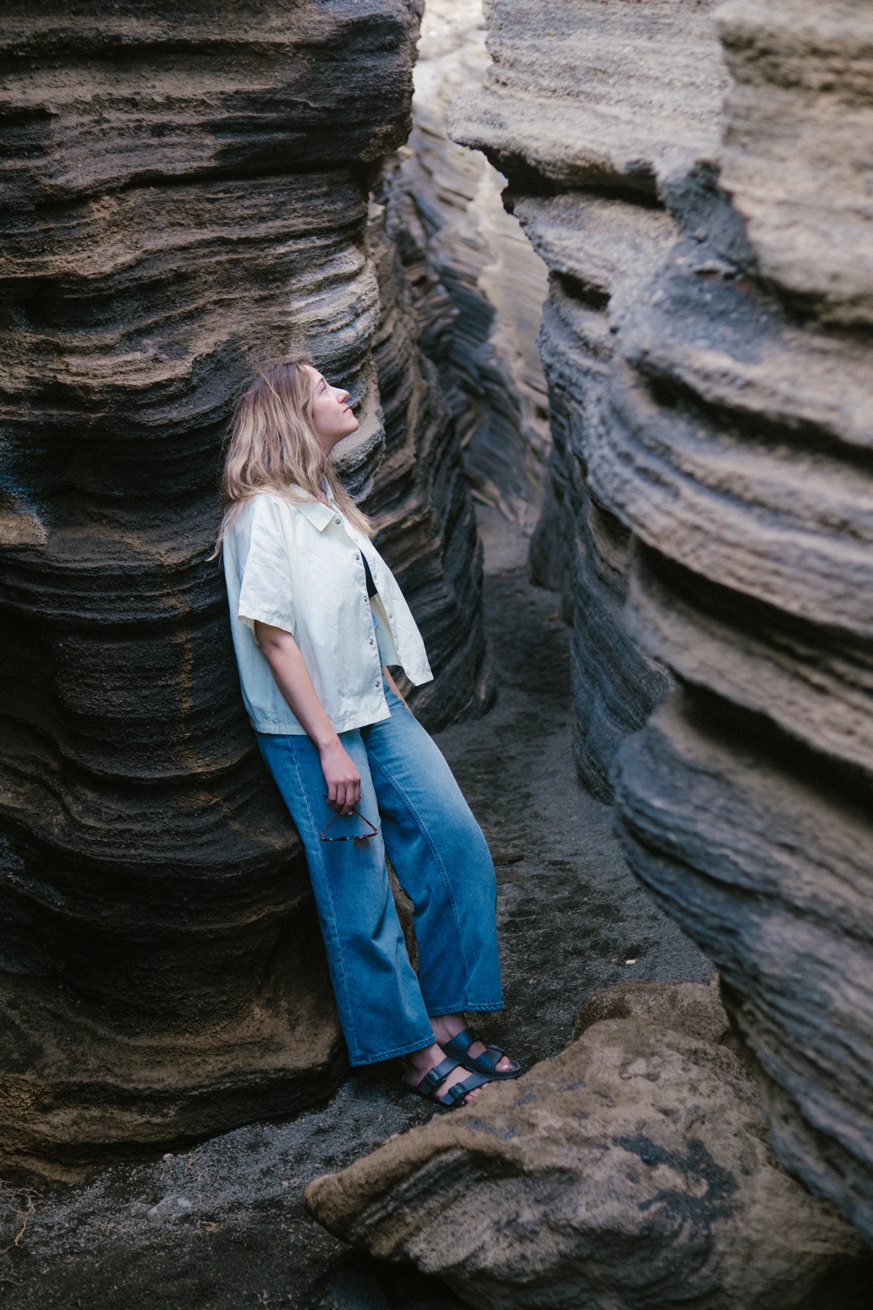 etizia posing between the high, layered volcanic walls of Las Grietas.