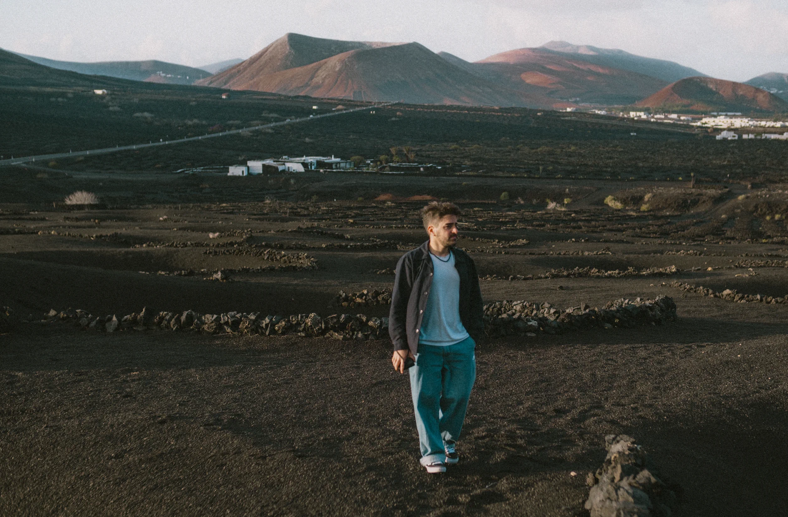Ieser walking through the volcanic vineyards of La Geria.