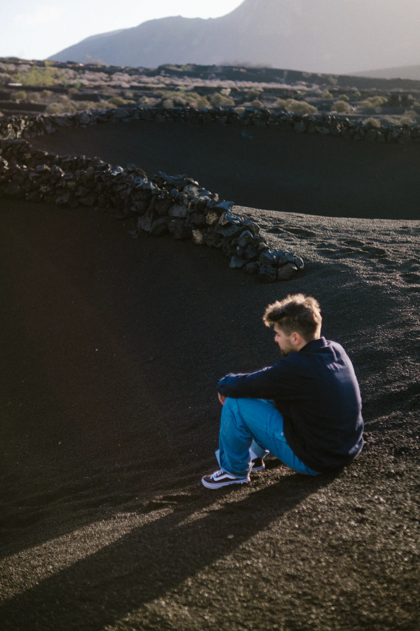 Ieser sitting at the edge of a volcanic vineyard in La Geria.