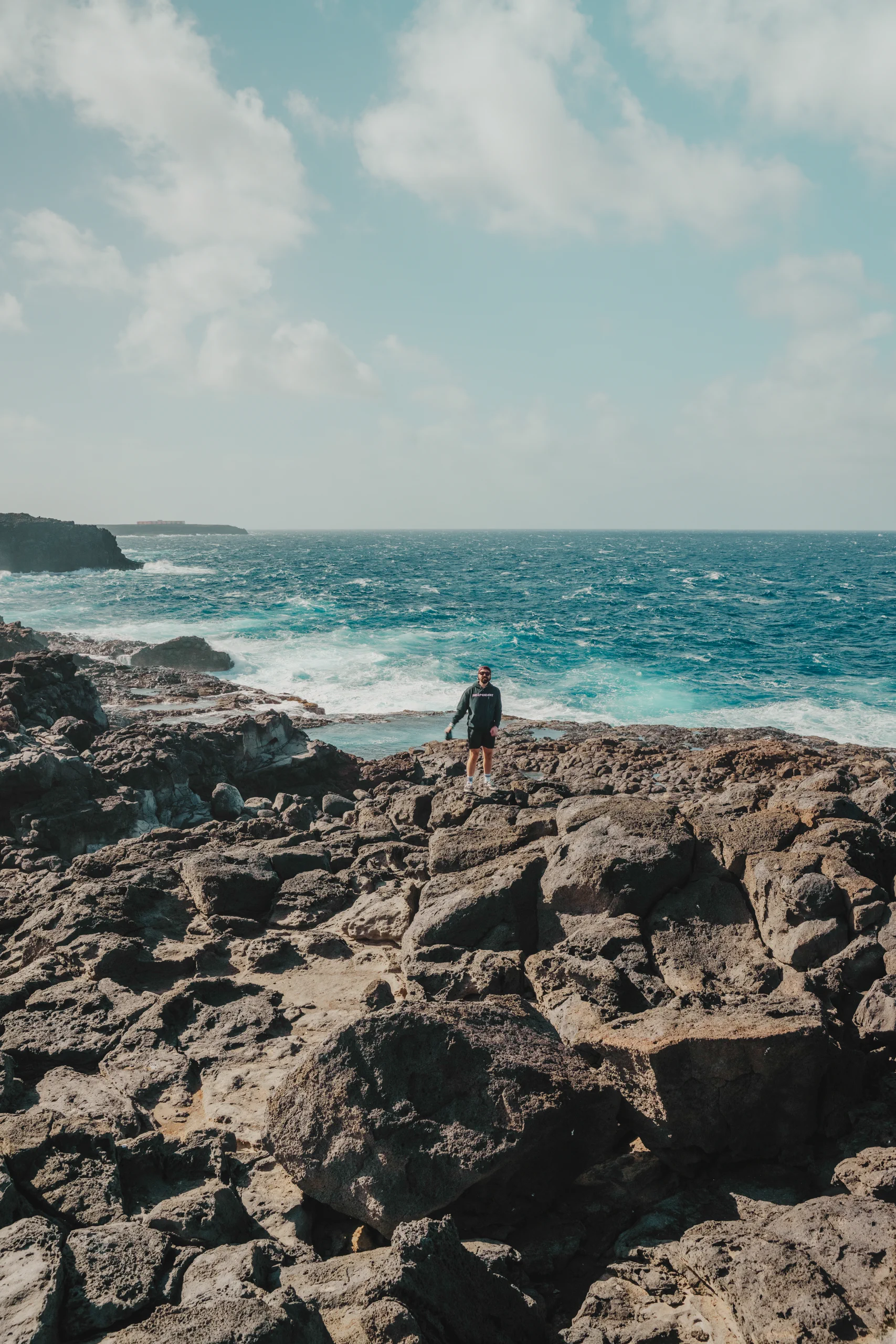 Iair standing on the dark volcanic cliffs of southern Lanzarote.
